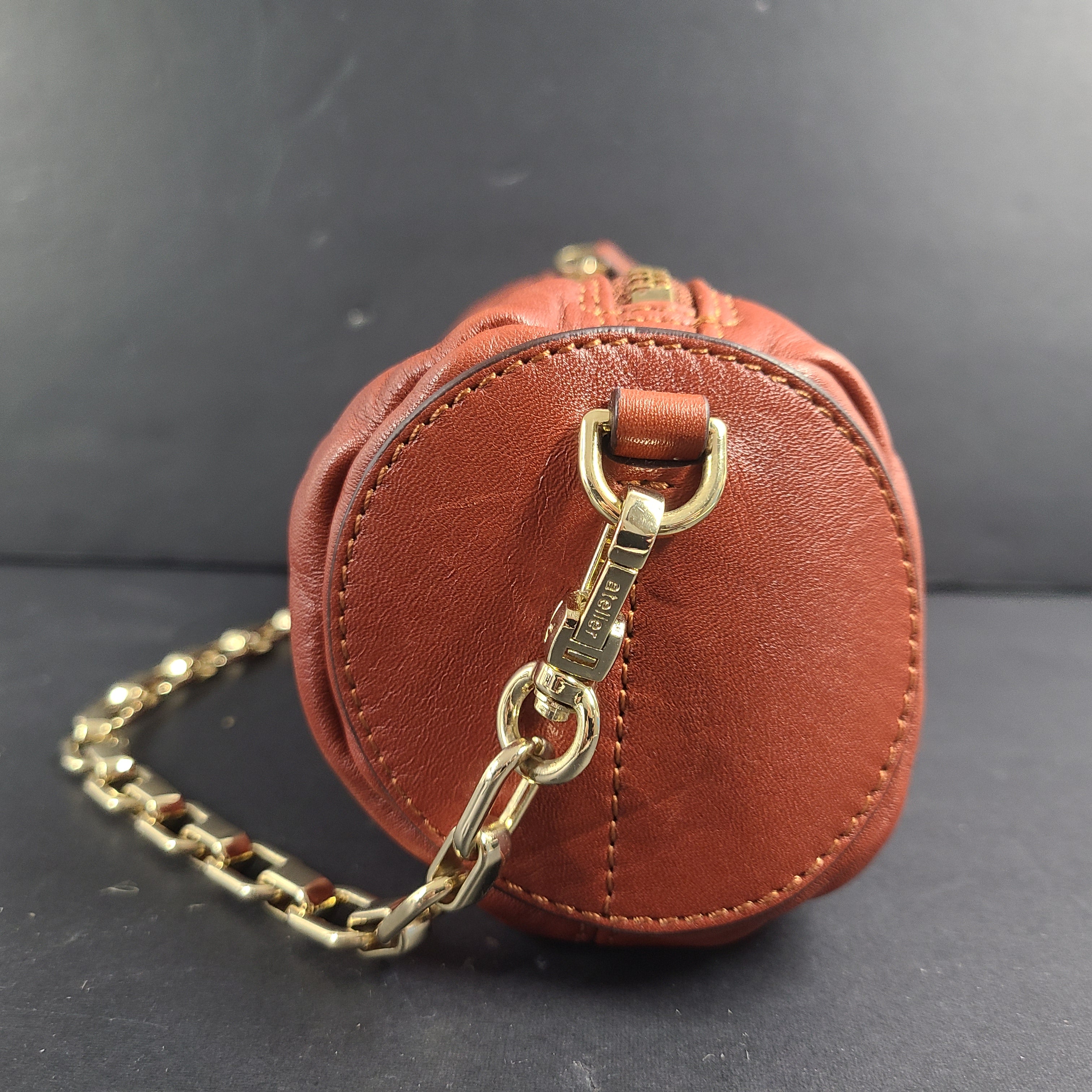 A stylish brown leather handbag with chain strap