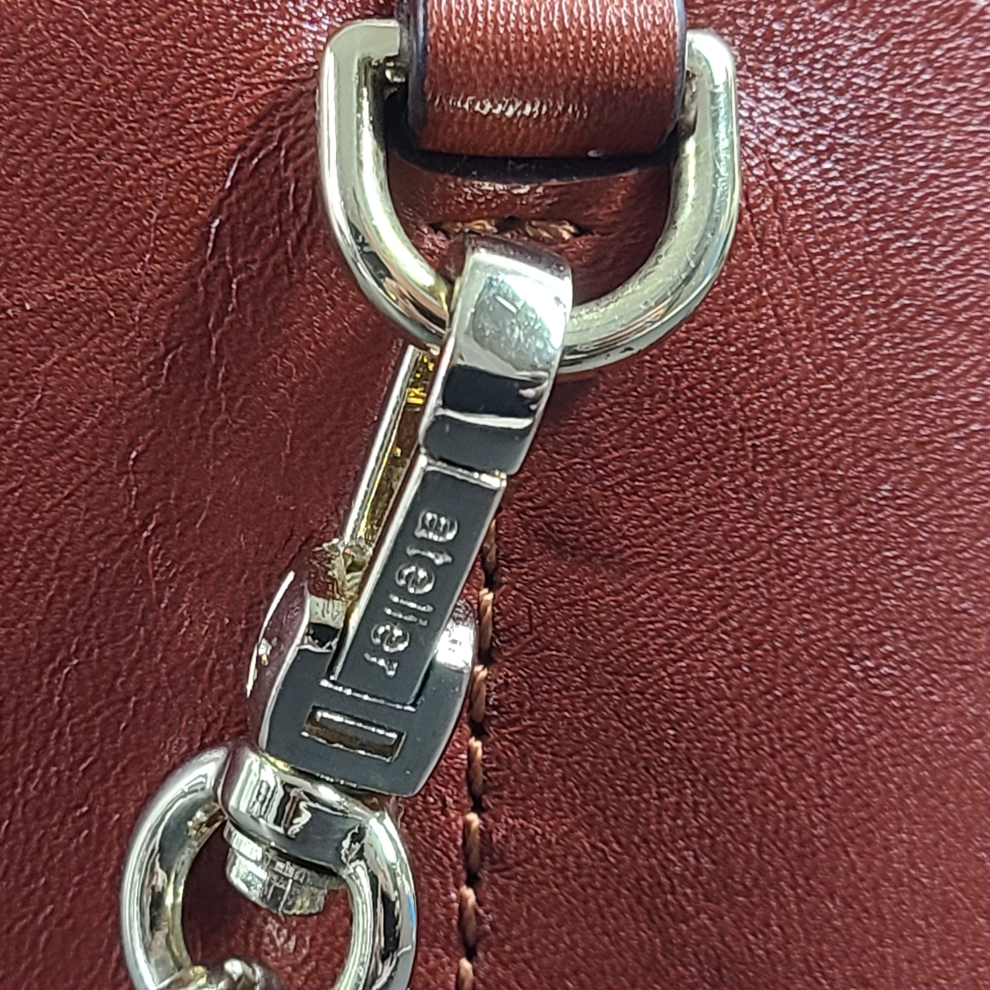 A stylish brown leather handbag with chain strap