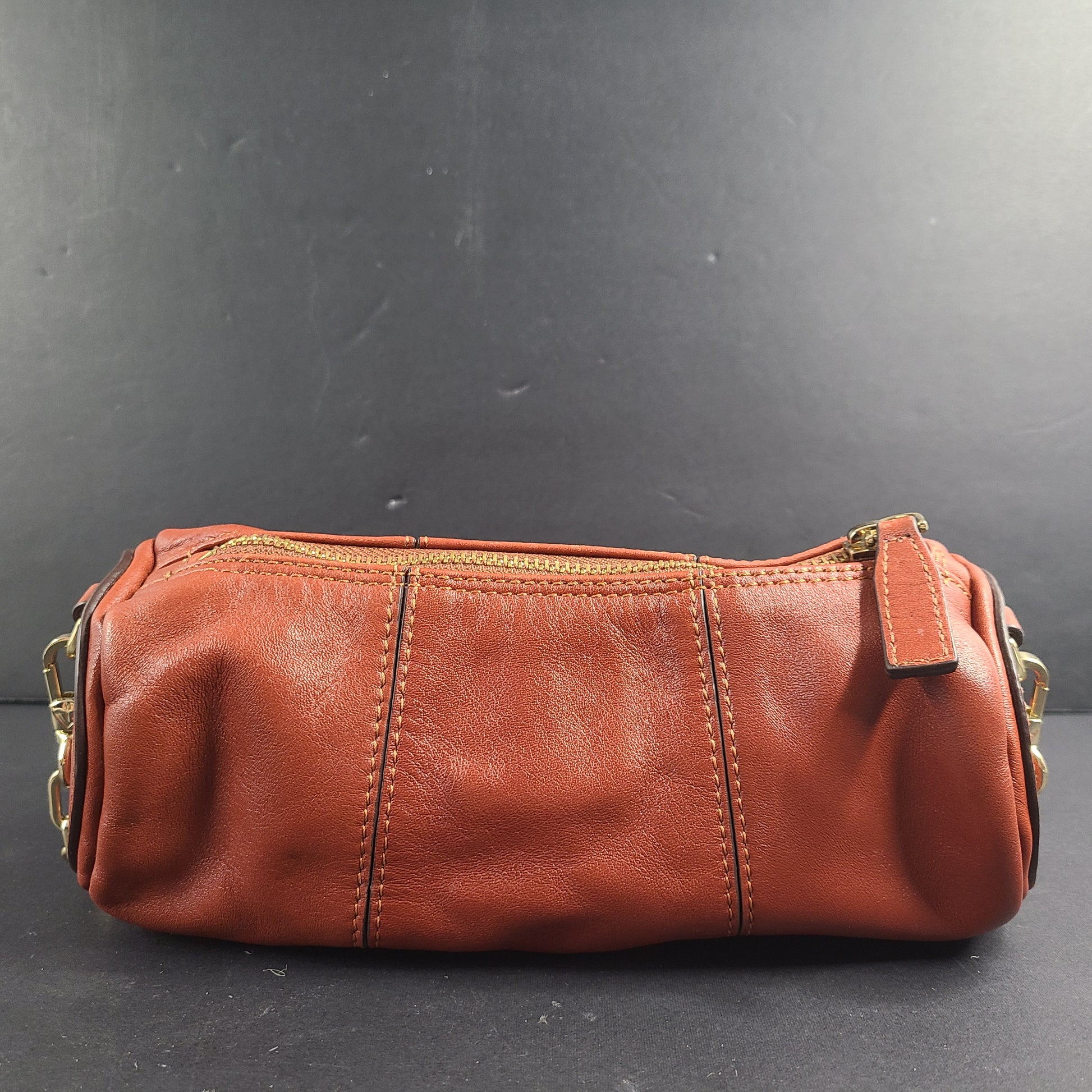 A stylish brown leather handbag with chain strap