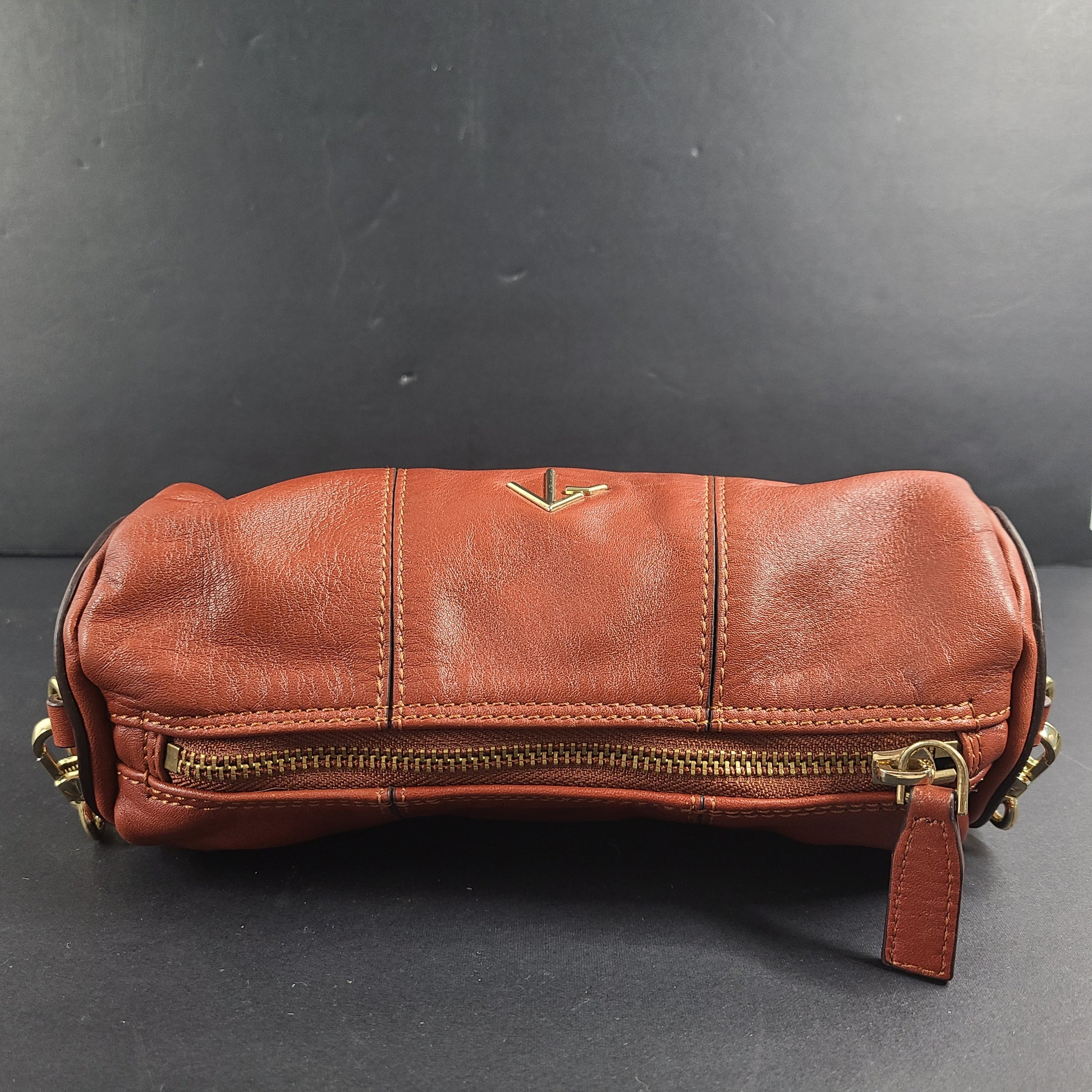 A stylish brown leather handbag with chain strap