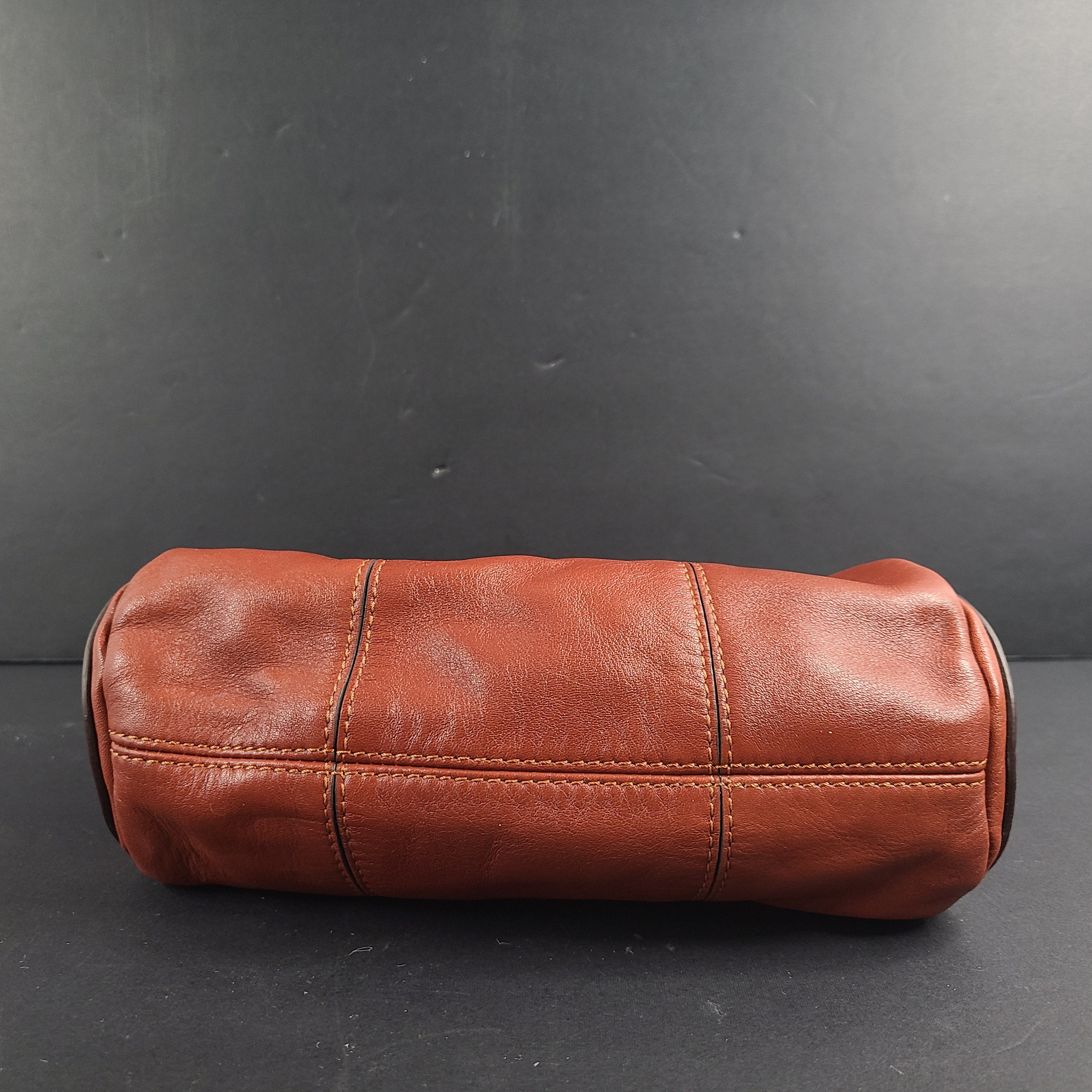 A stylish brown leather handbag with chain strap