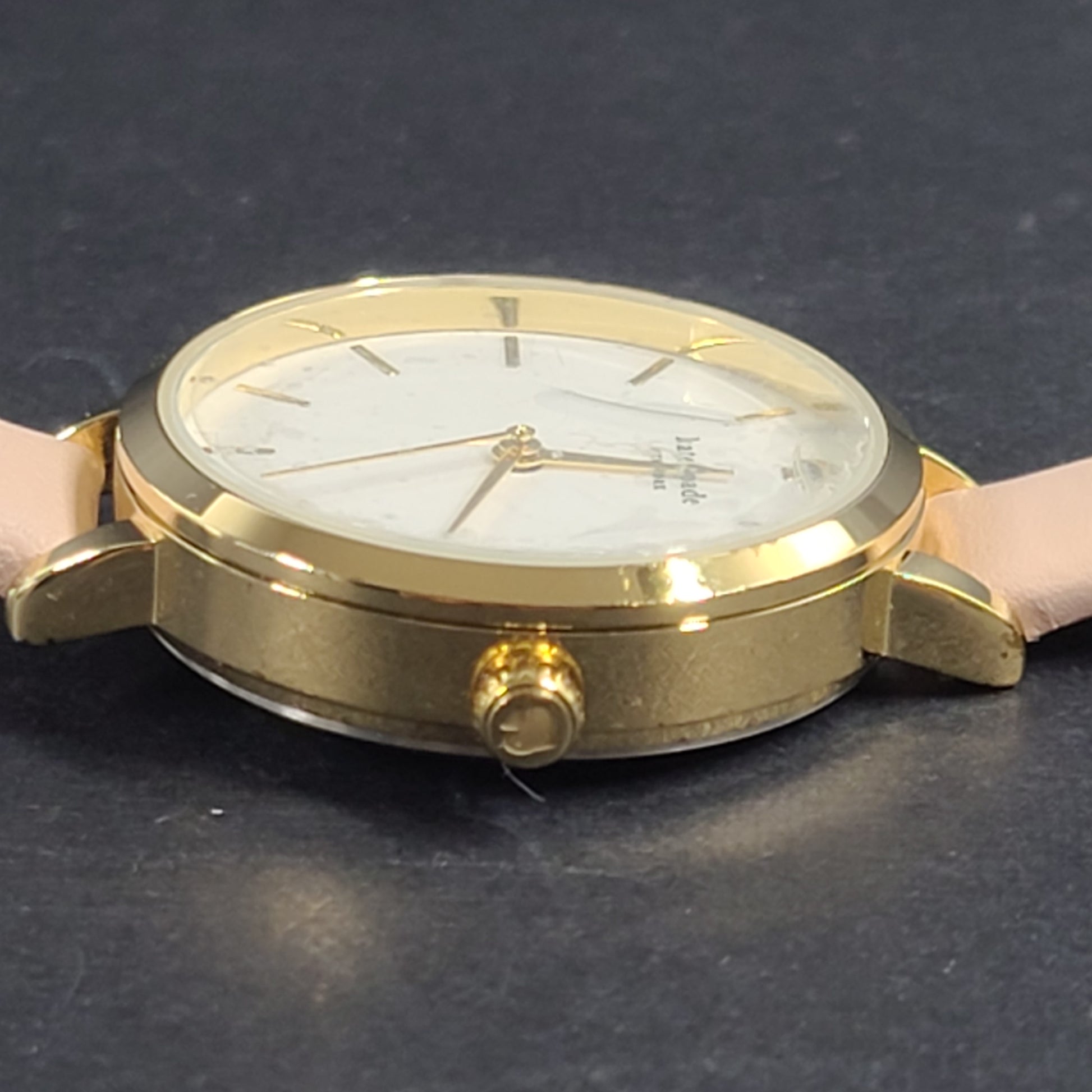 A stylish Kate Spade New York women's watch in gold and pink