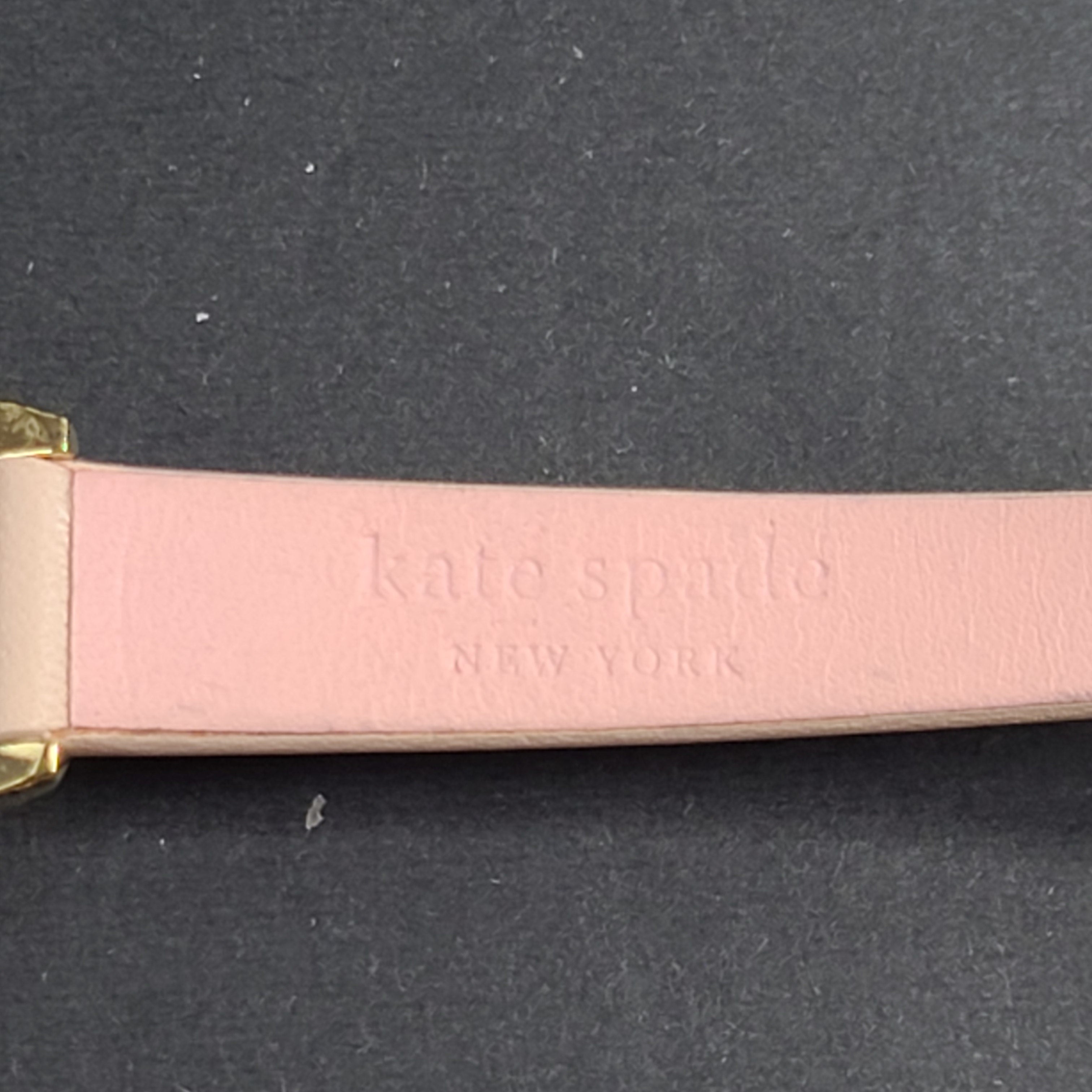 A stylish Kate Spade New York women's watch in gold and pink
