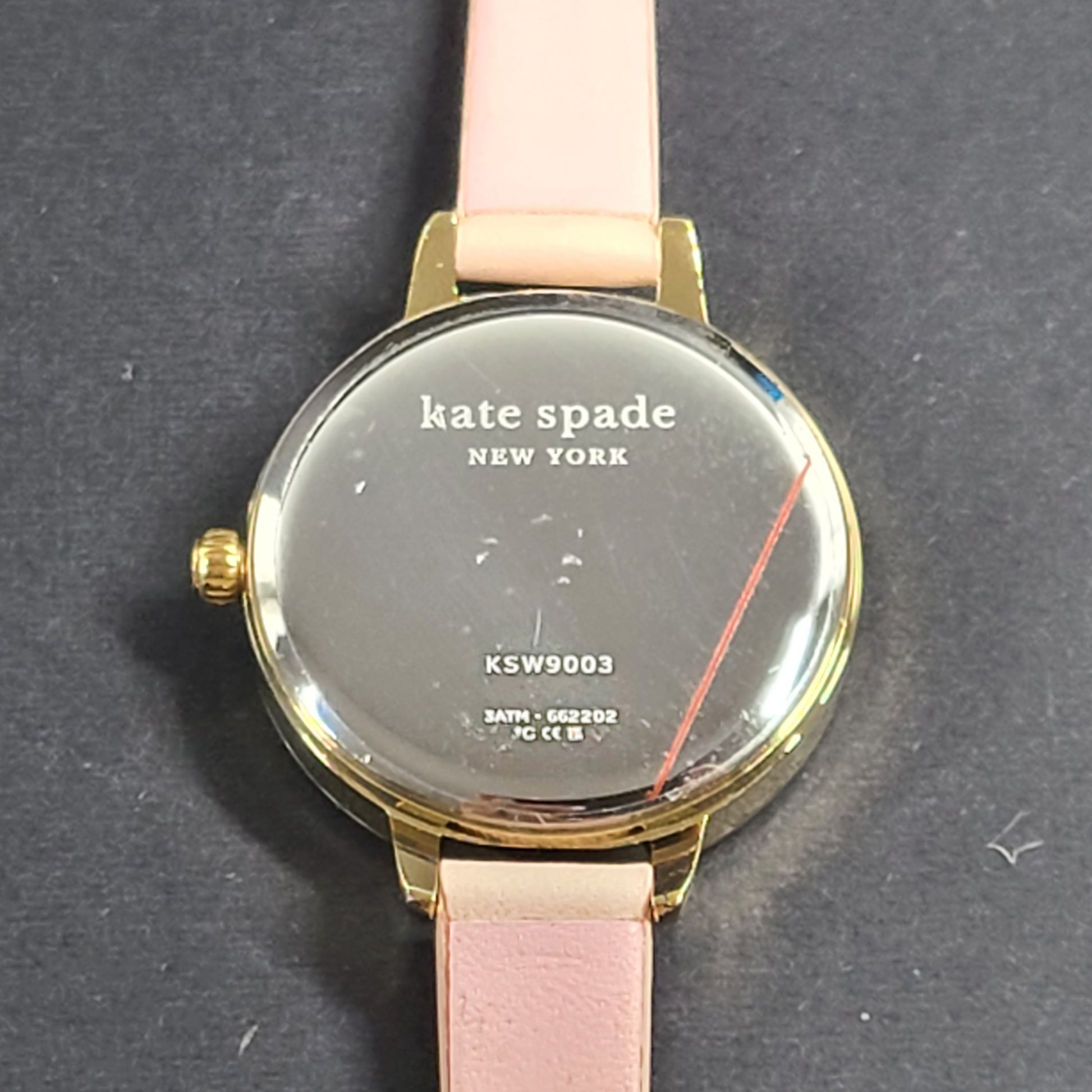 A stylish Kate Spade New York women's watch in gold and pink