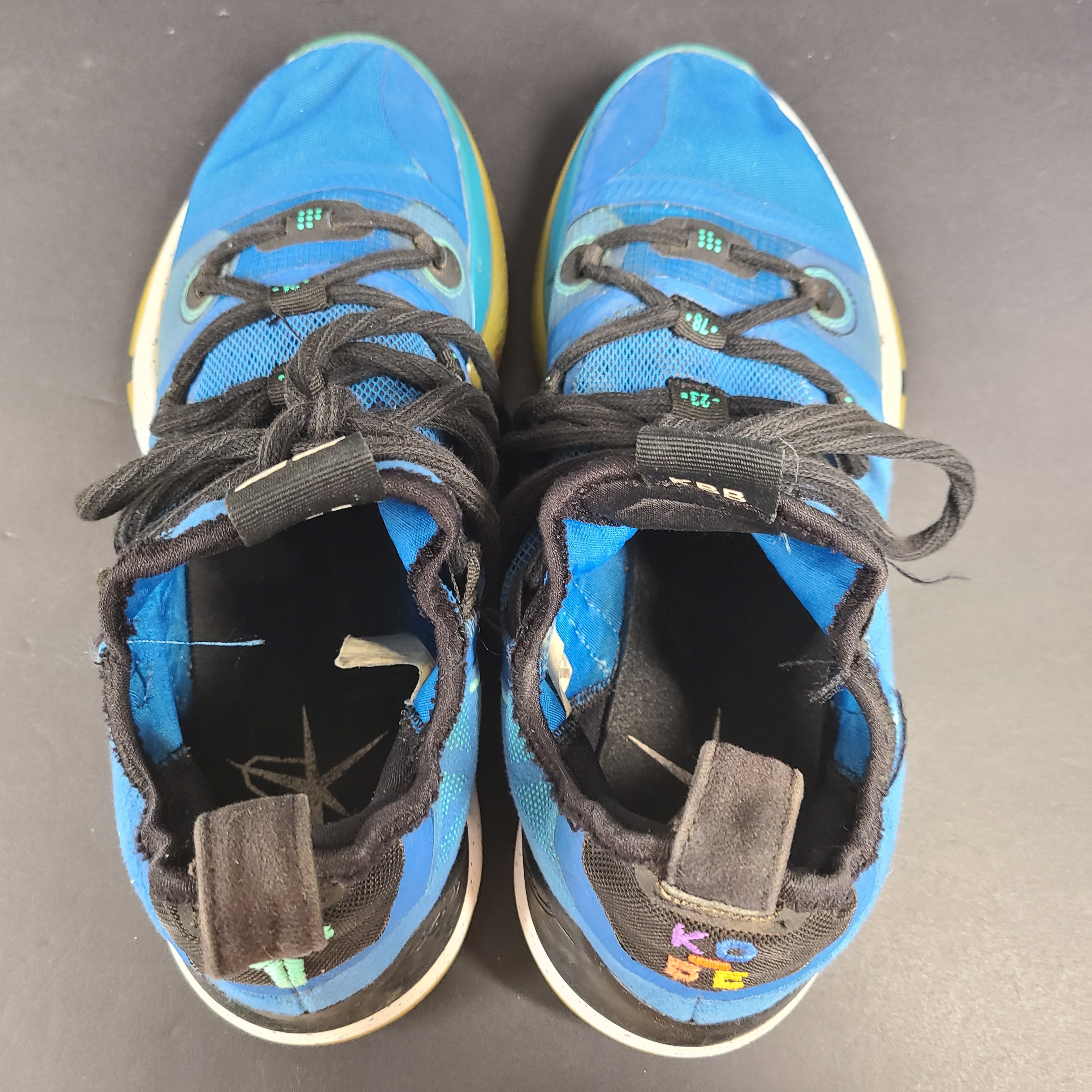 A pair of Nike Kobe AD NXT 360 Basketball Shoes in blue and yellow