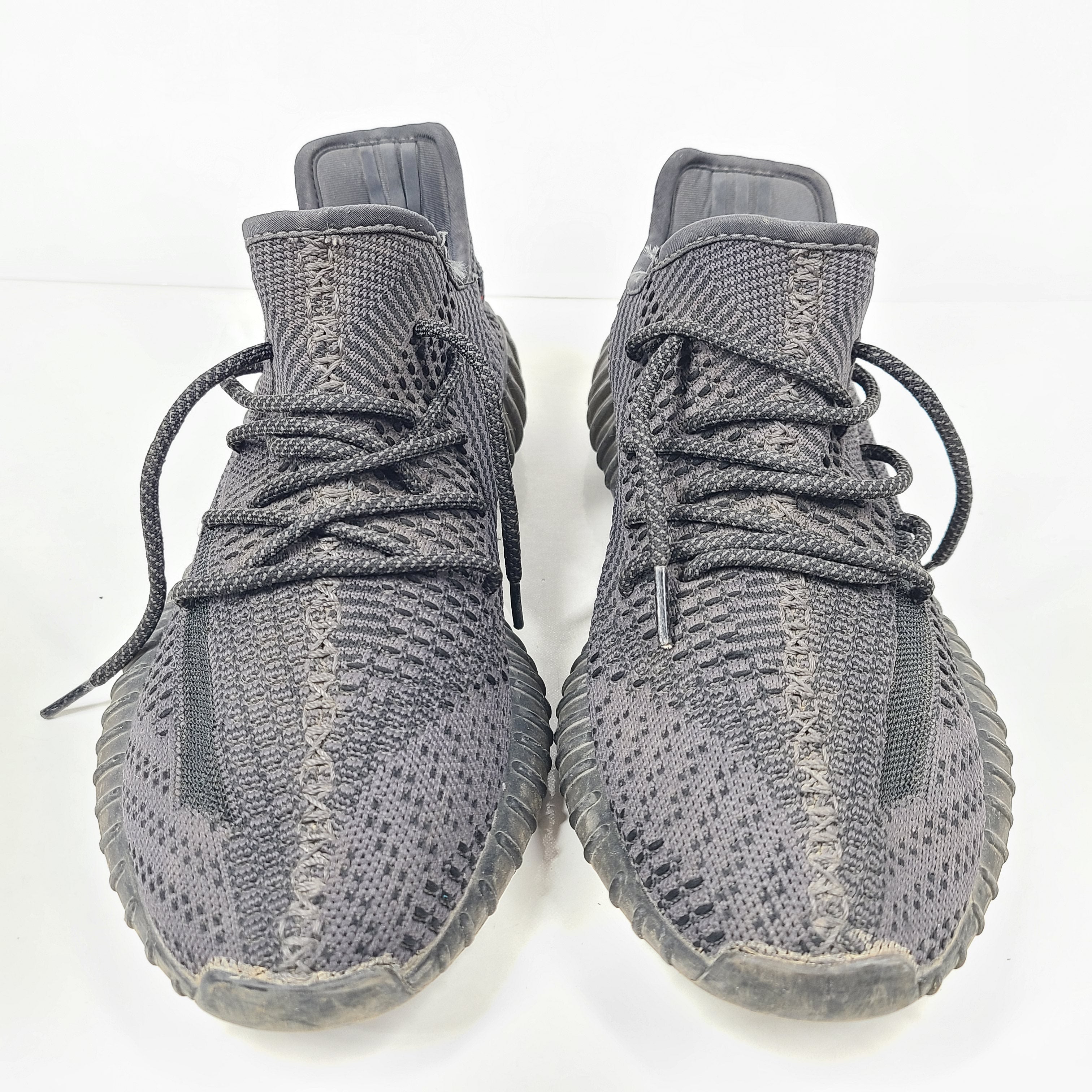 A pair of black and gray Adidas Yeezy Boost 350 V2 sneakers in size 10.5