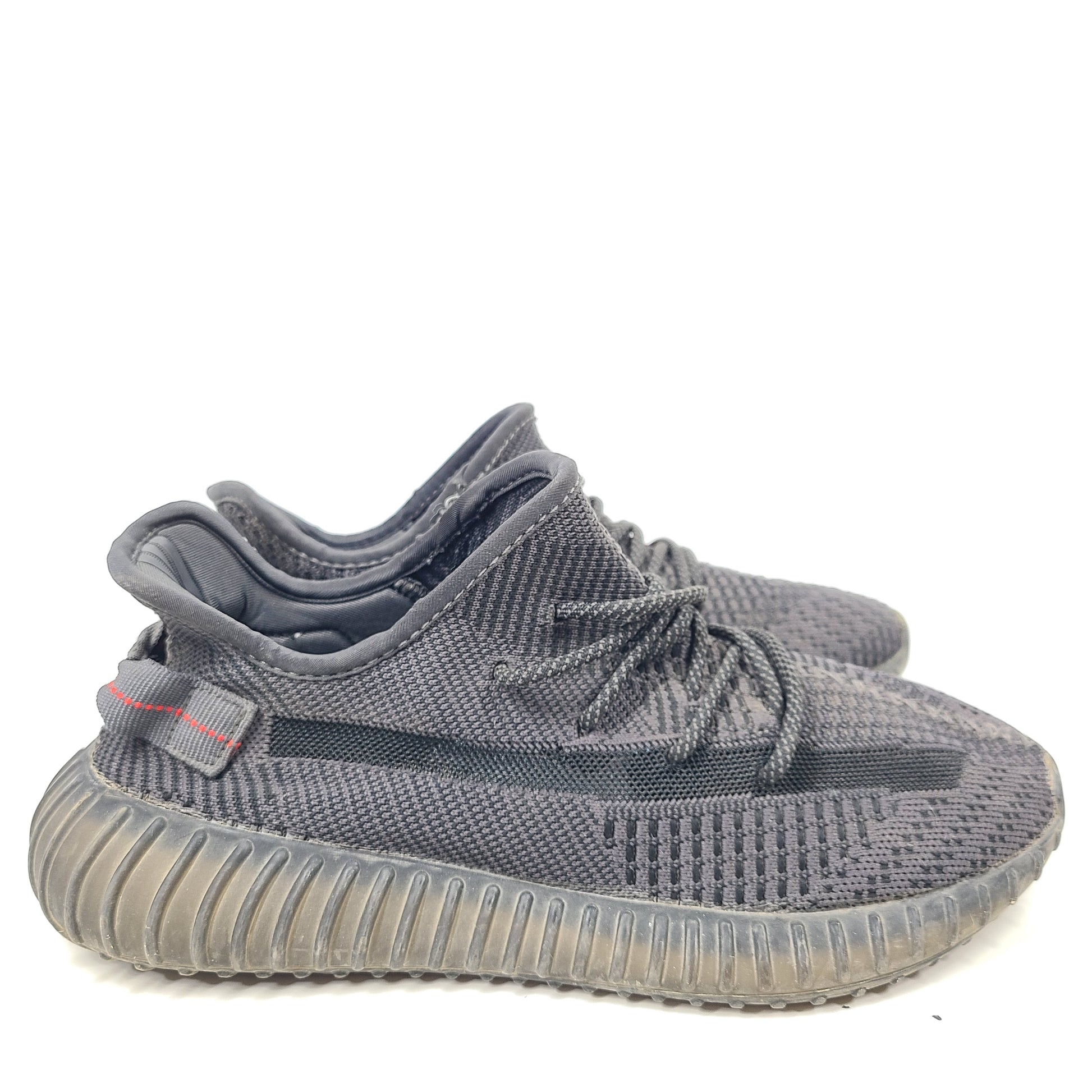 A pair of black and gray Adidas Yeezy Boost 350 V2 sneakers in size 10.5