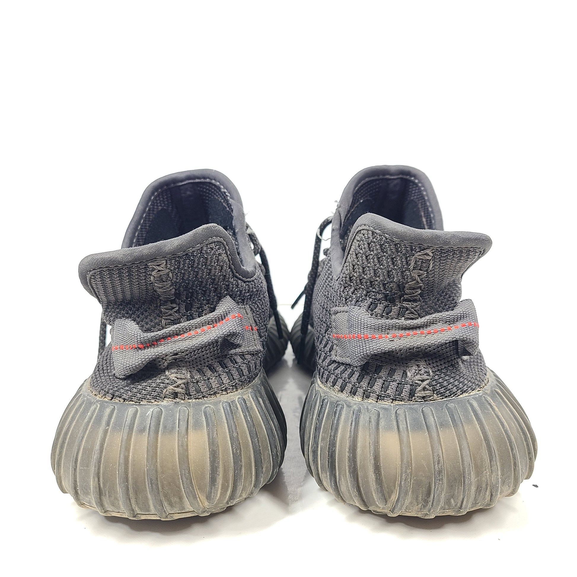A pair of black and gray Adidas Yeezy Boost 350 V2 sneakers in size 10.5