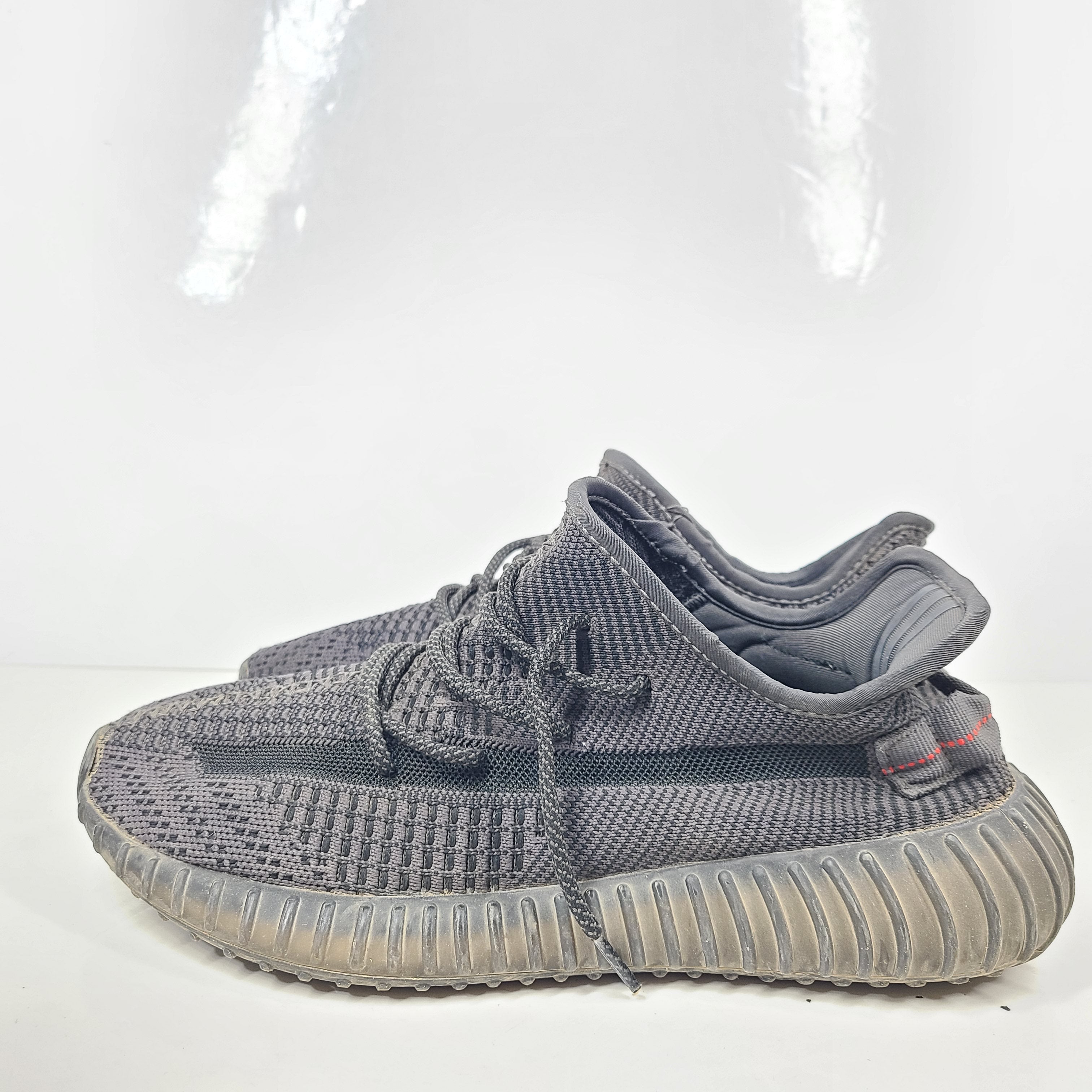 A pair of black and gray Adidas Yeezy Boost 350 V2 sneakers in size 10.5