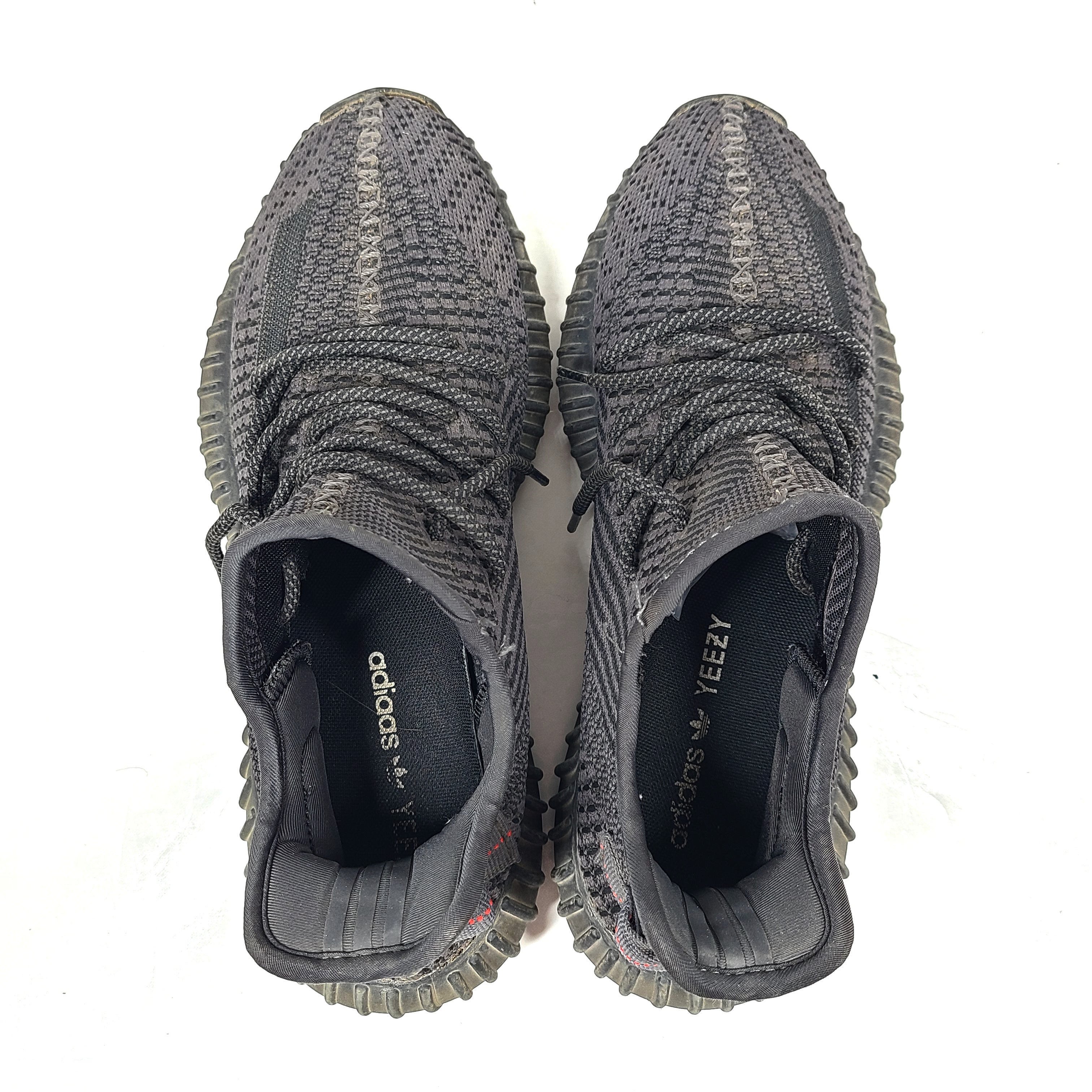 A pair of black and gray Adidas Yeezy Boost 350 V2 sneakers in size 10.5