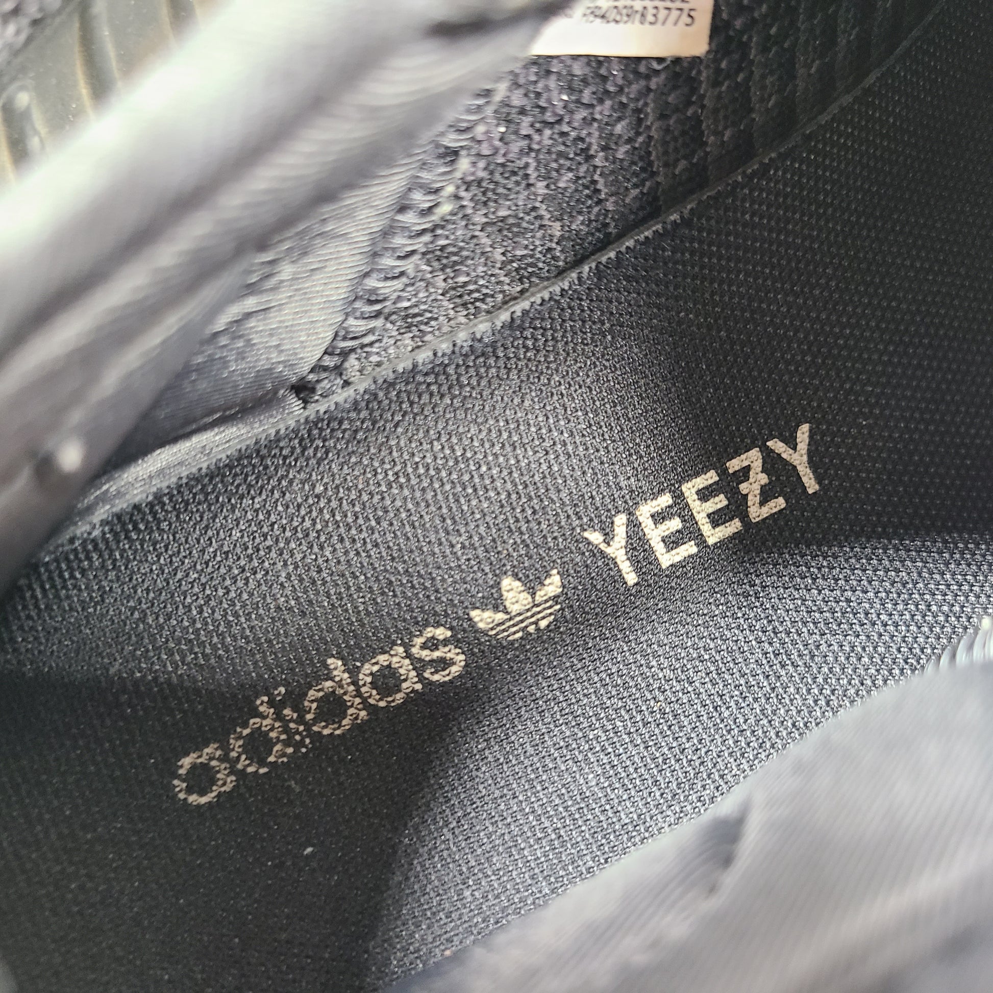 A pair of black and gray Adidas Yeezy Boost 350 V2 sneakers in size 10.5