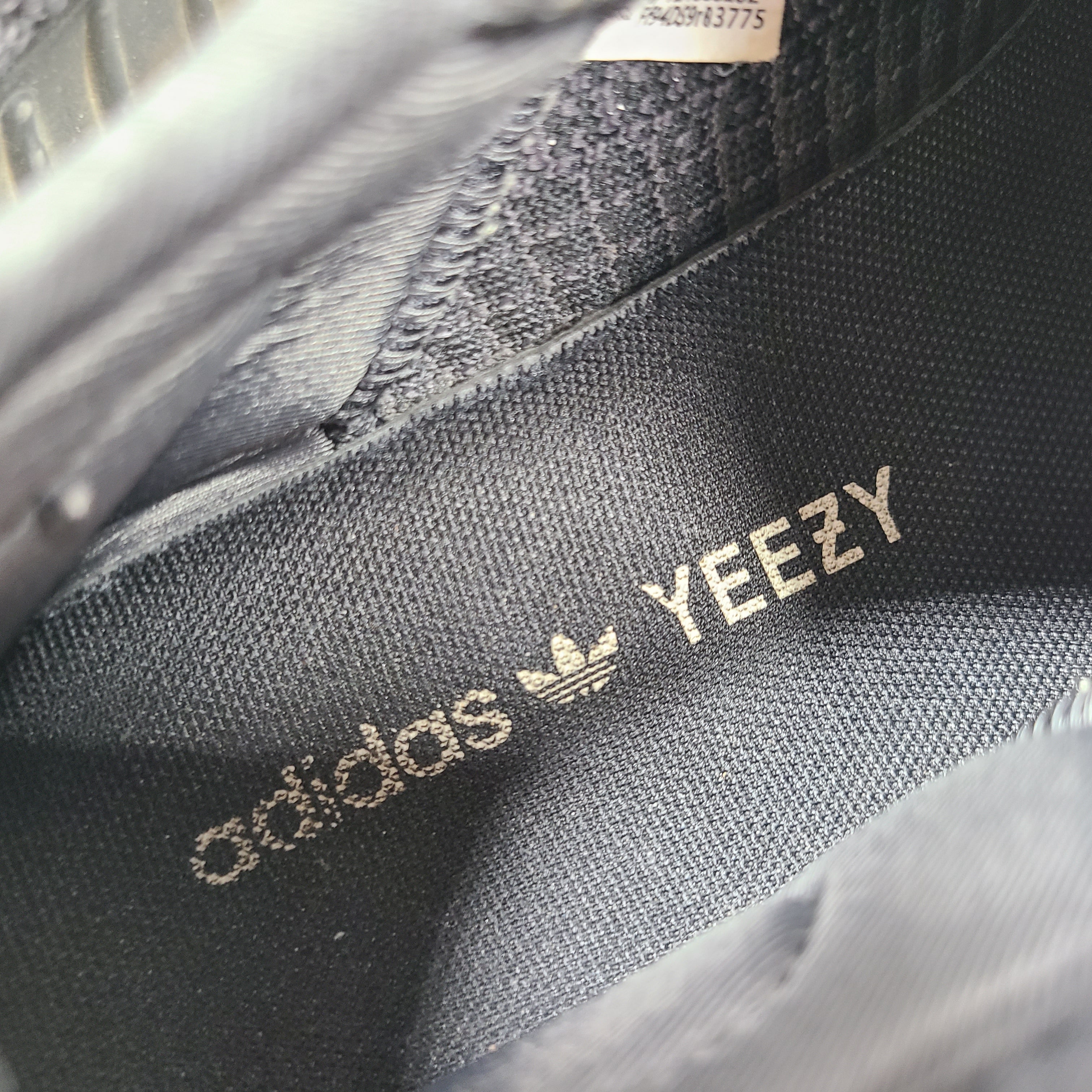 A pair of black and gray Adidas Yeezy Boost 350 V2 sneakers in size 10.5
