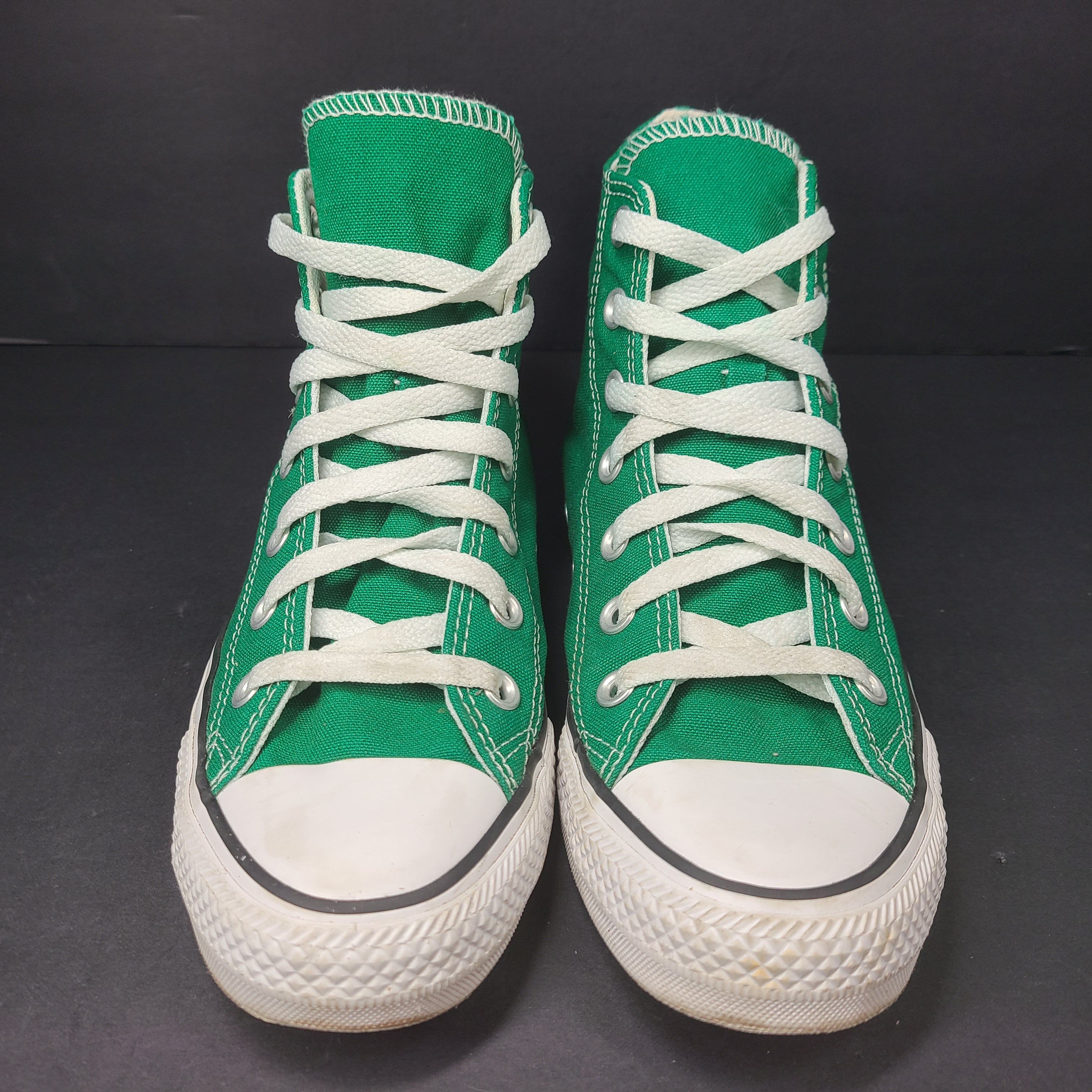 A pair of green Converse All Star high top sneakers for men and women.