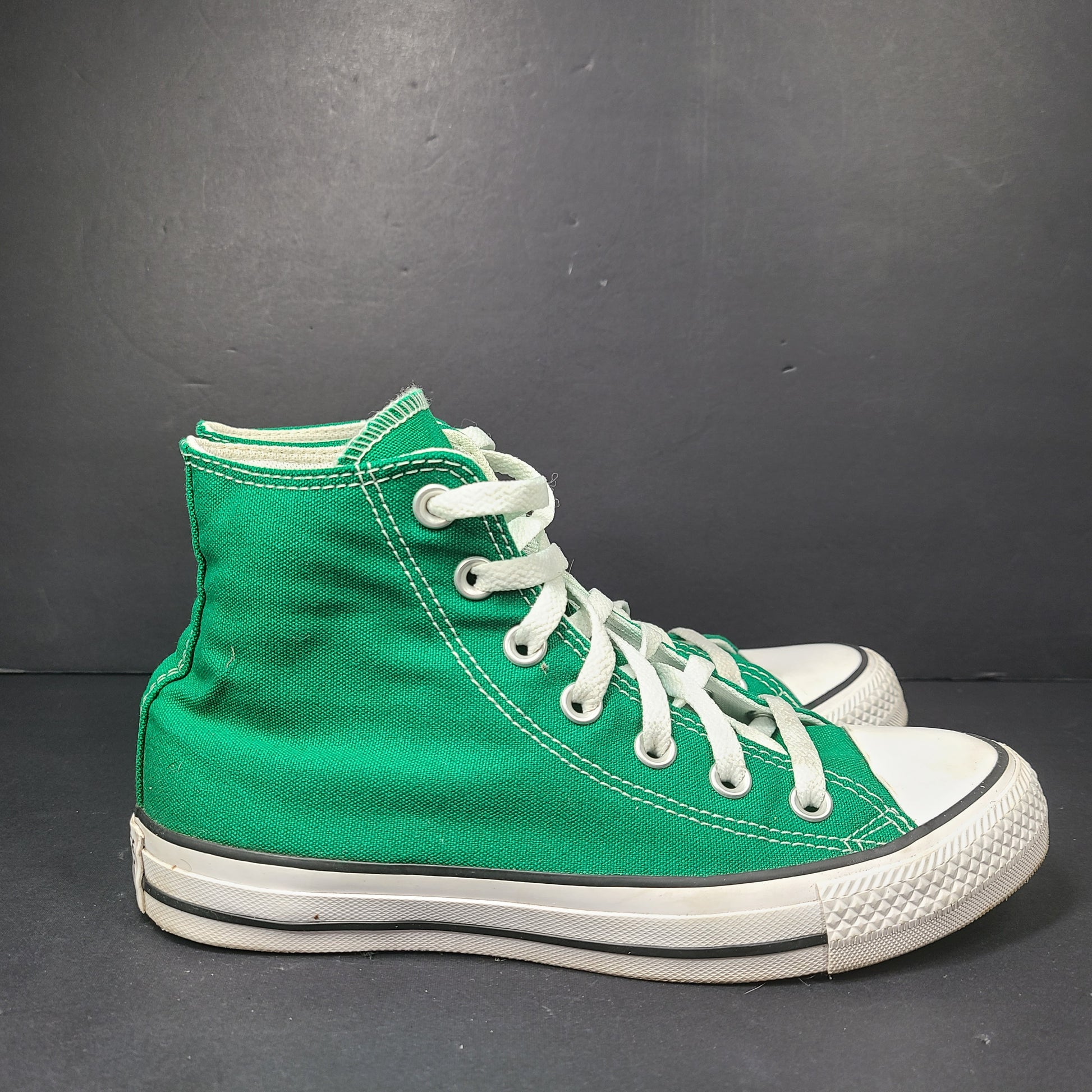A pair of green Converse All Star high top sneakers for men and women.