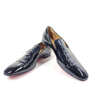 A pair of black patent leather loafers by Christian Louboutin