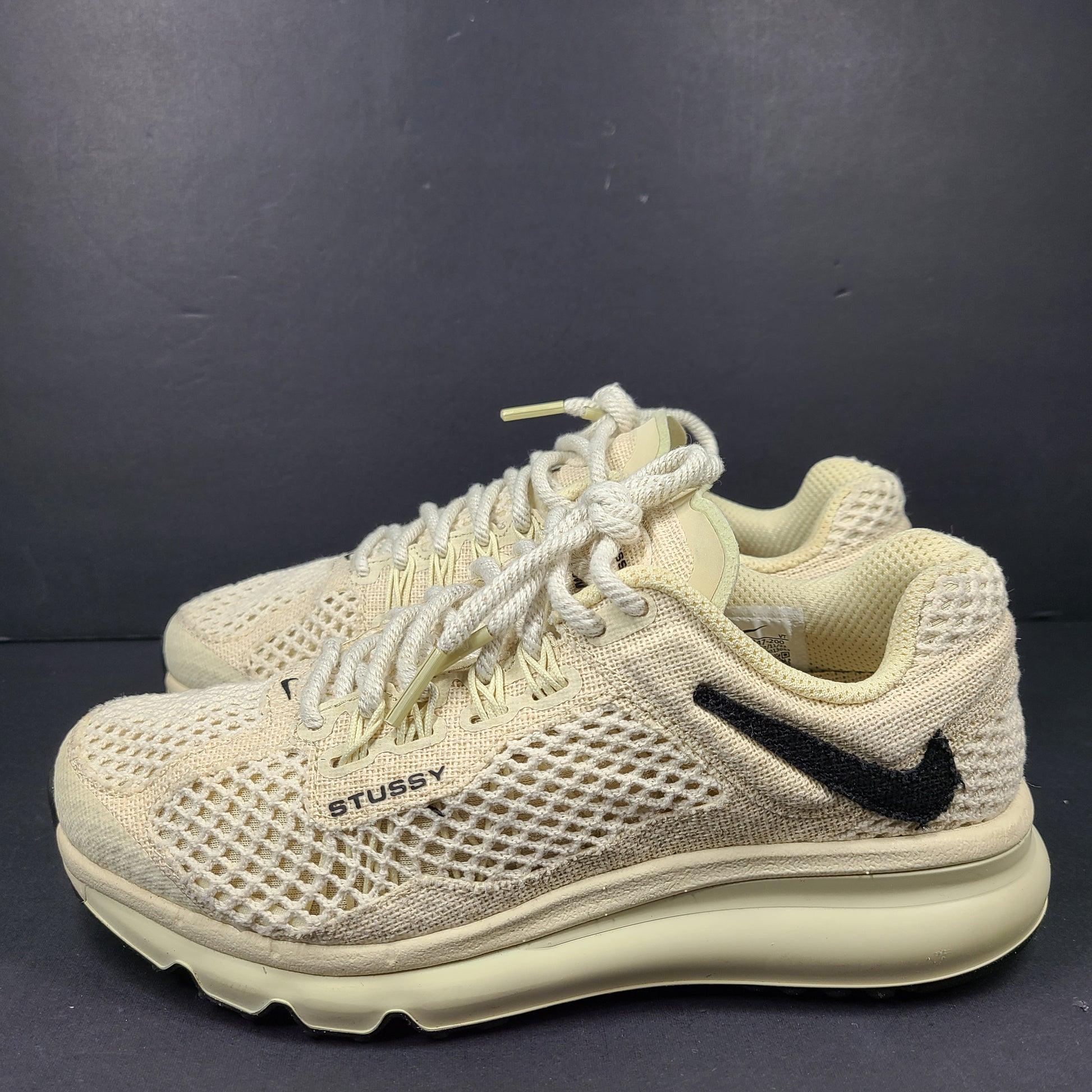A pair of beige Nike x Stussy Air Max sneakers