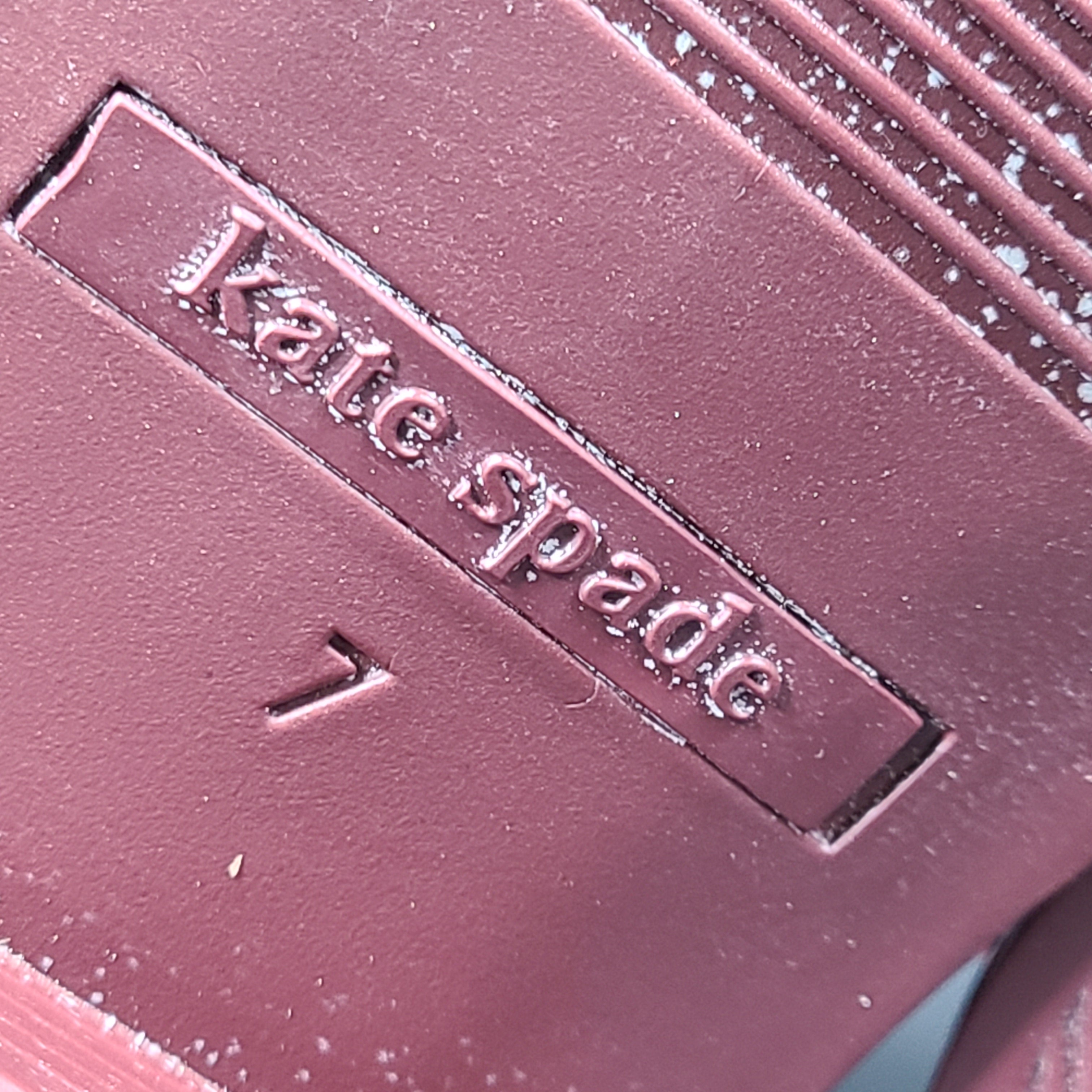 A stylish pair of Kate Spade Chelsea Ankle Boots in burgundy color
