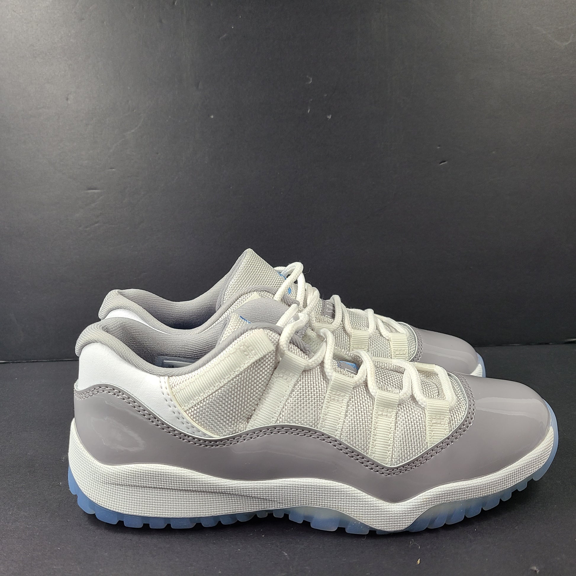 A pair of Nike Air Jordan 11 Retro Low Gray Blue Youth Size 3Y sneakers.