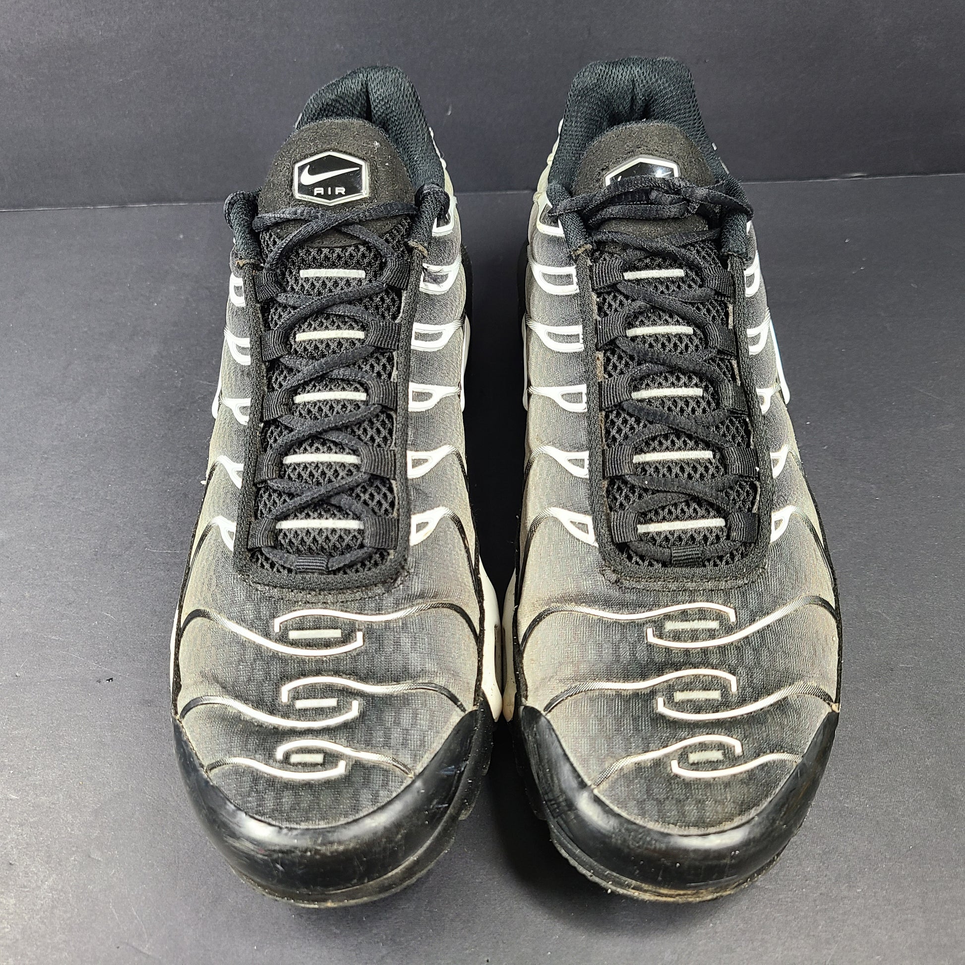 A pair of stylish Nike Air Max Plus Tn DM0032-003 Black/White Men's Shoes Size 8.5