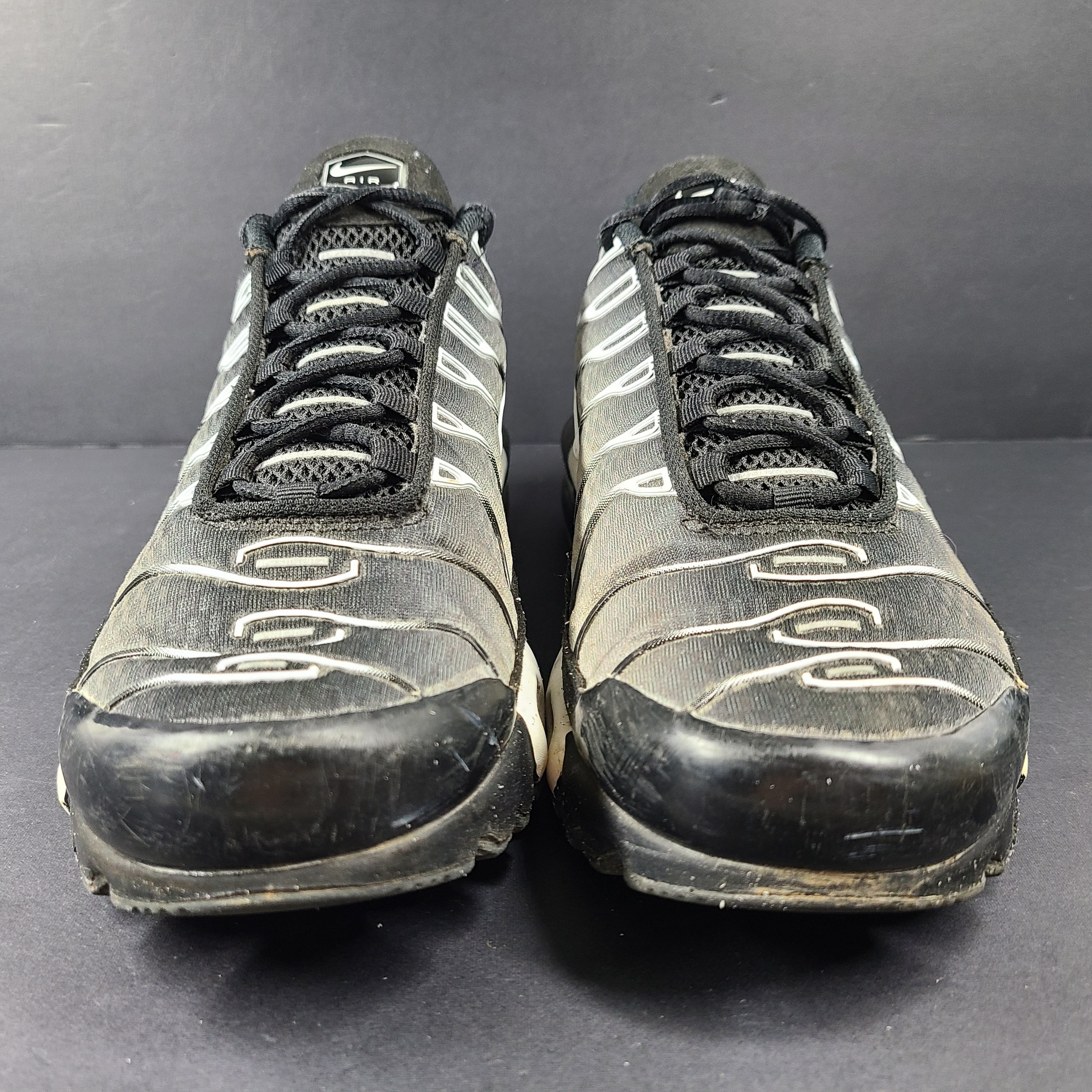 A pair of stylish Nike Air Max Plus Tn DM0032-003 Black/White Men's Shoes Size 8.5