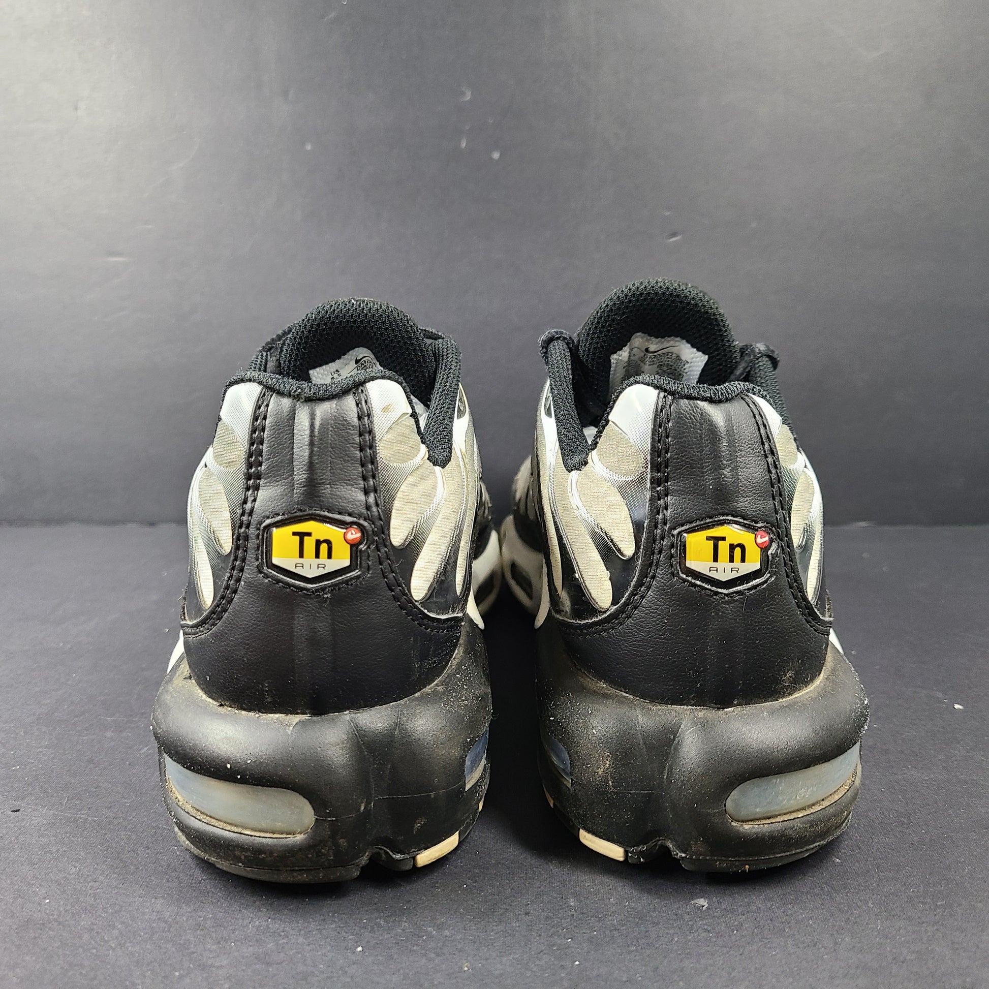 A pair of stylish Nike Air Max Plus Tn DM0032-003 Black/White Men's Shoes Size 8.5