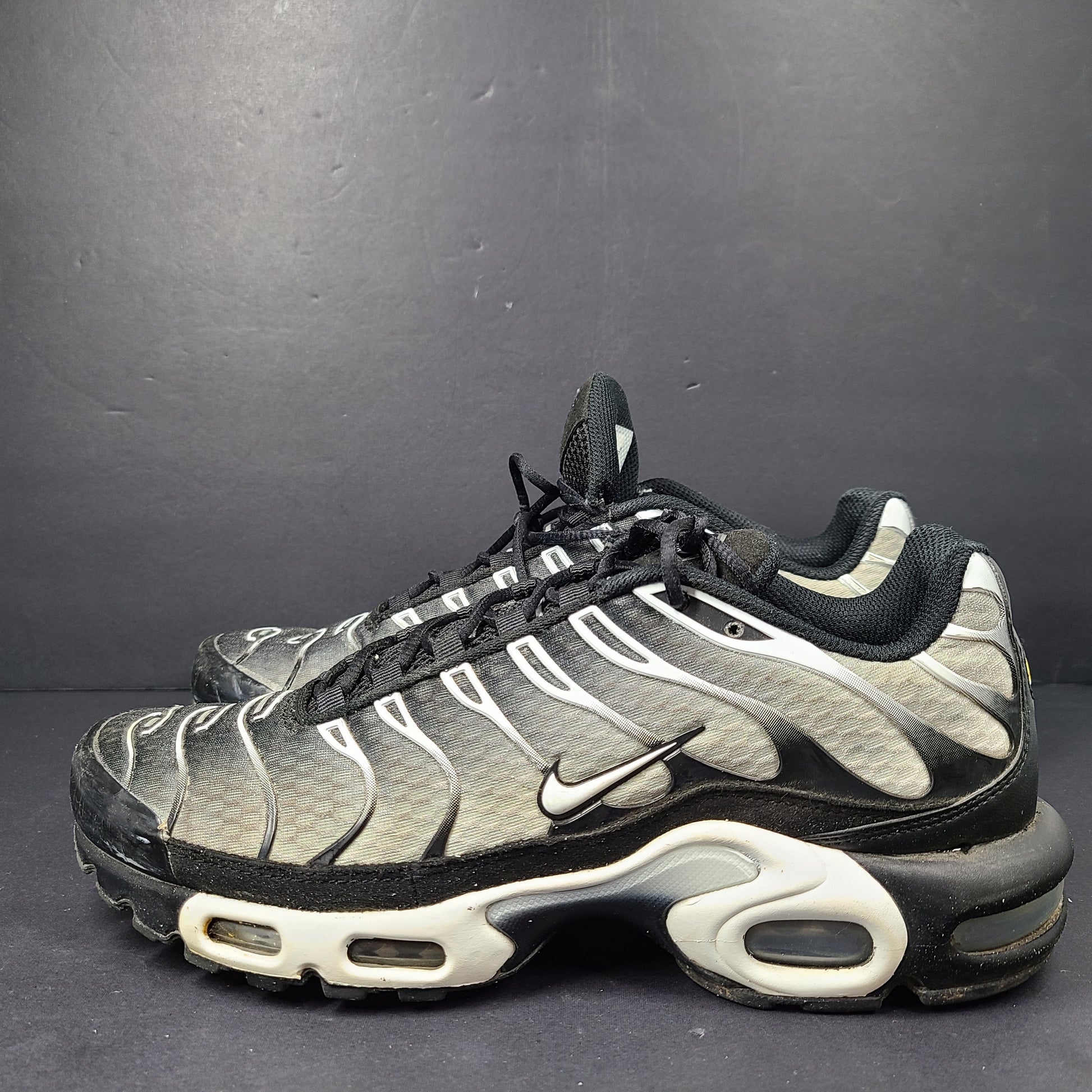 A pair of stylish Nike Air Max Plus Tn DM0032-003 Black/White Men's Shoes Size 8.5