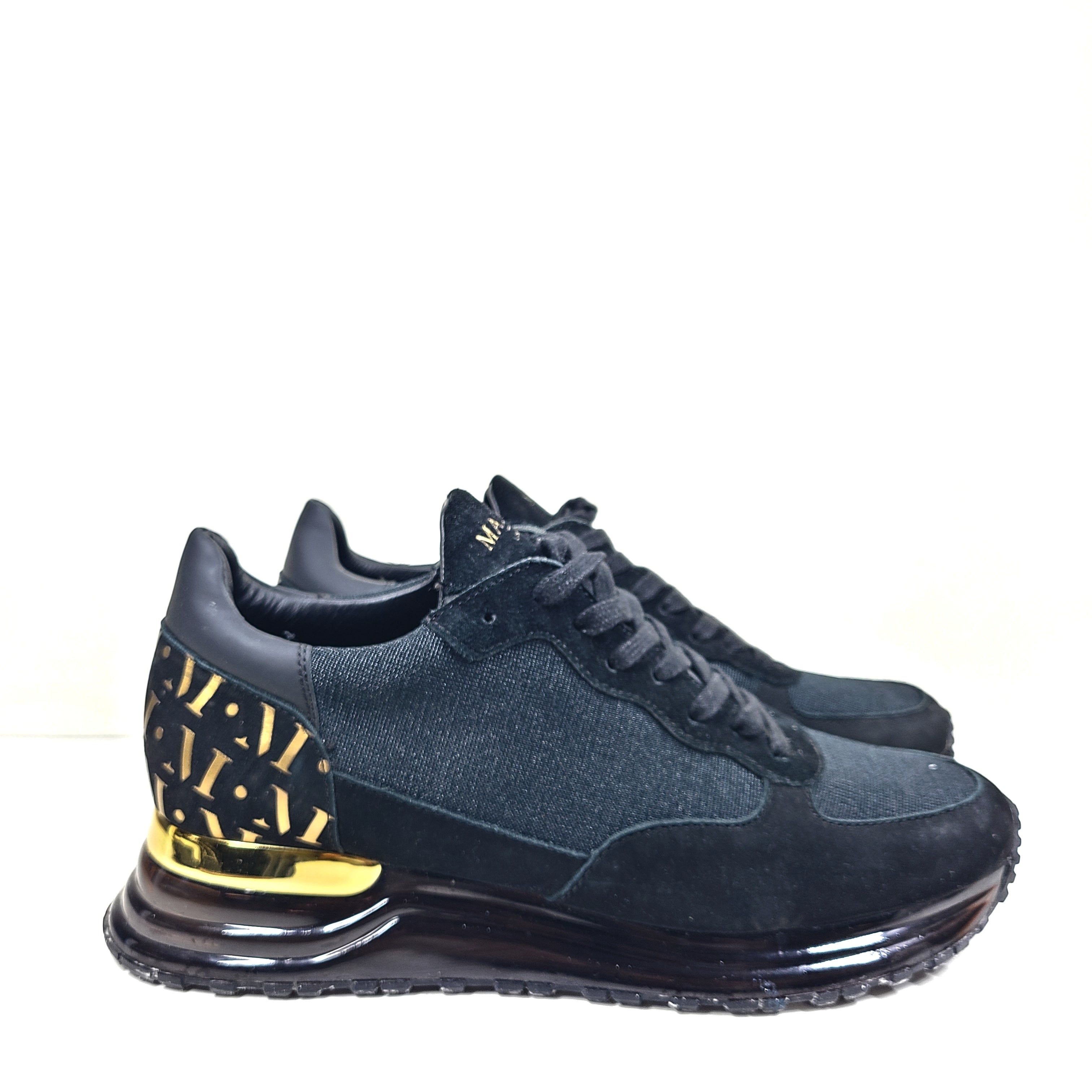A pair of sleek black and gold Mallet London sneakers