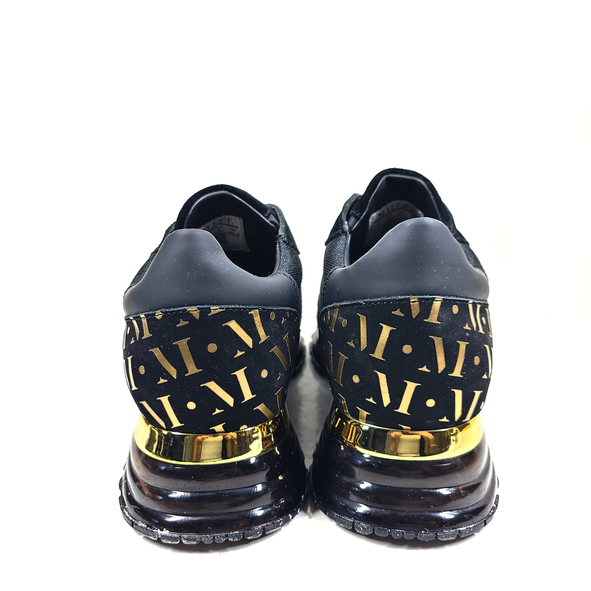 A pair of sleek black and gold Mallet London sneakers