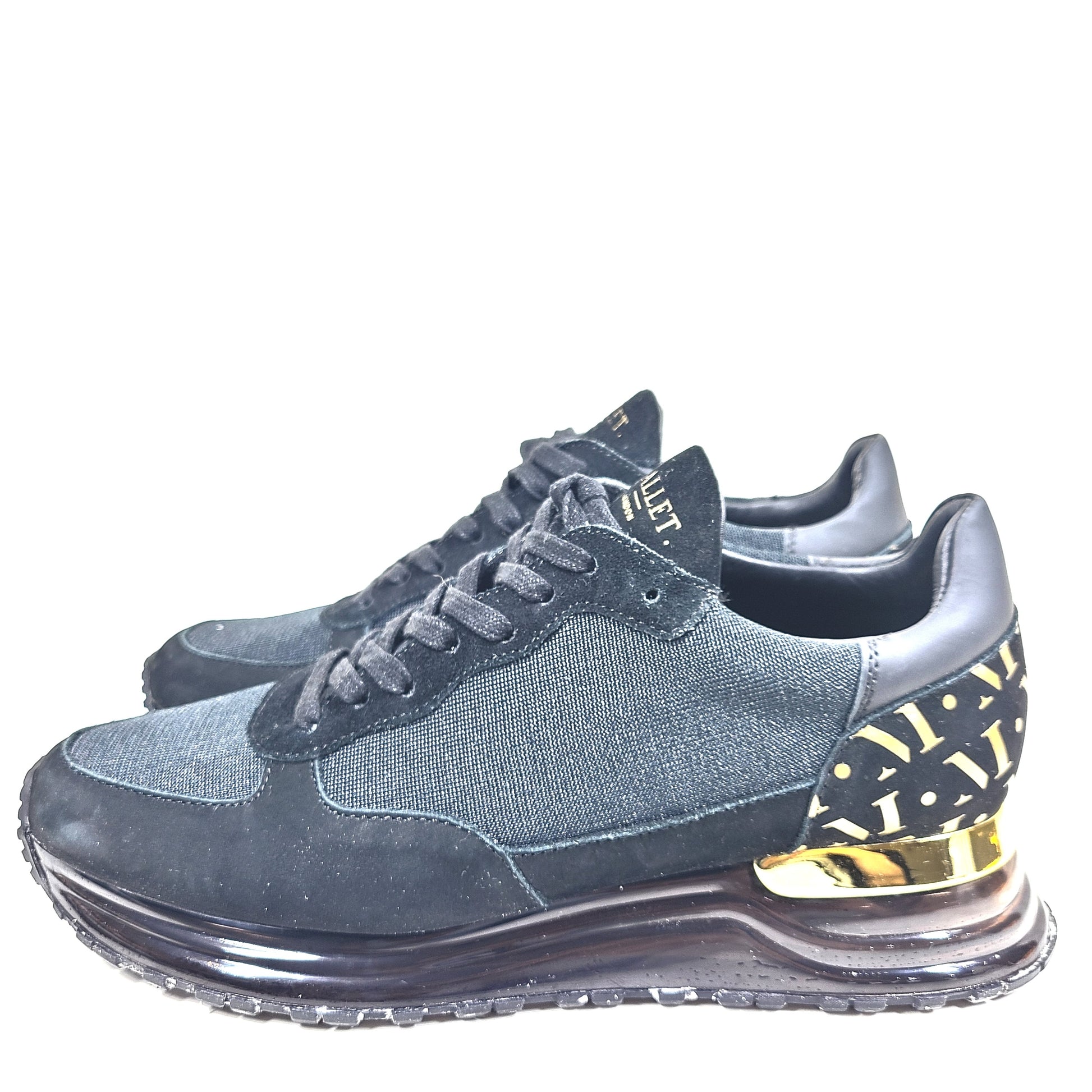 A pair of sleek black and gold Mallet London sneakers