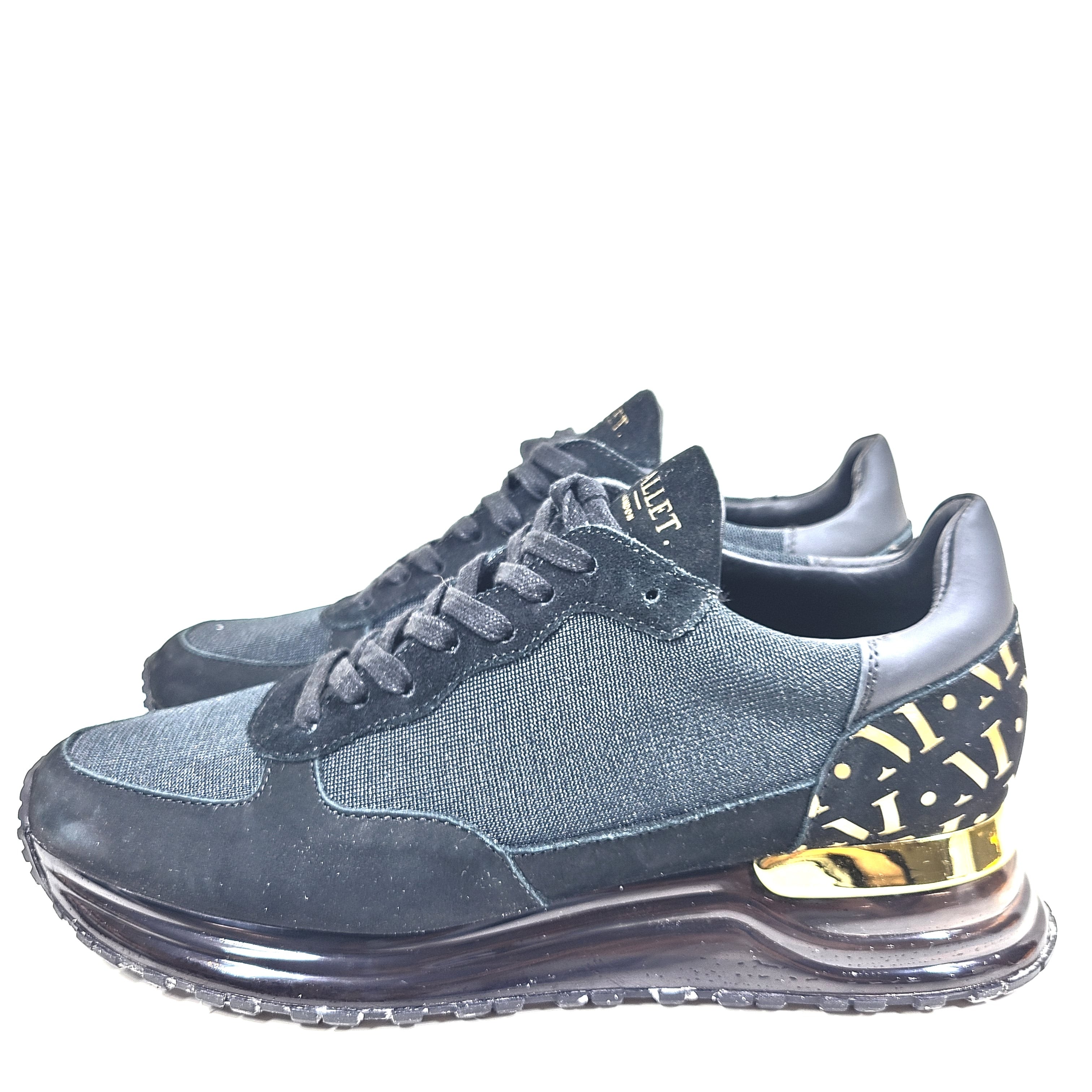 A pair of sleek black and gold Mallet London sneakers