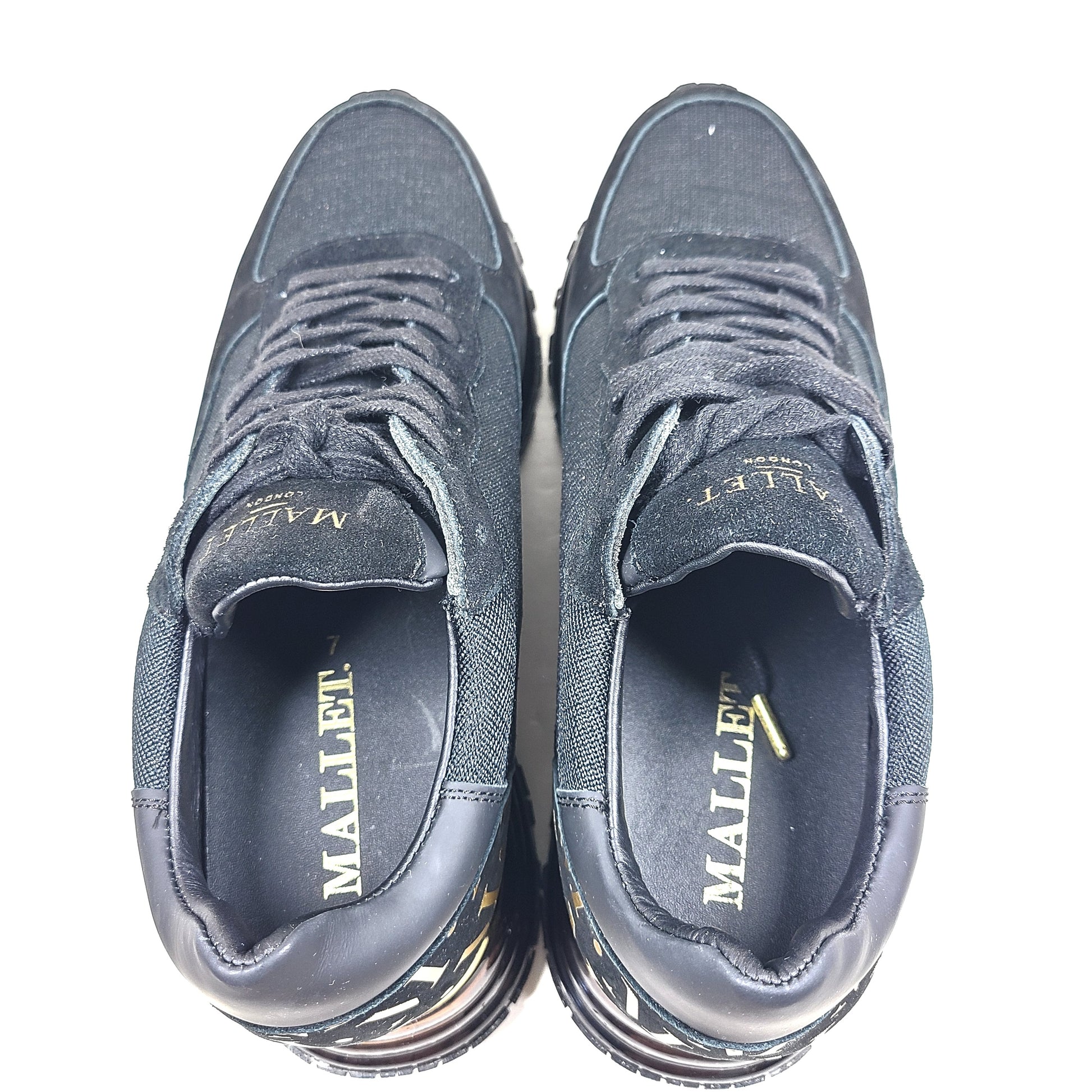 A pair of sleek black and gold Mallet London sneakers