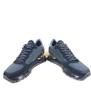 A pair of sleek black and gold Mallet London sneakers