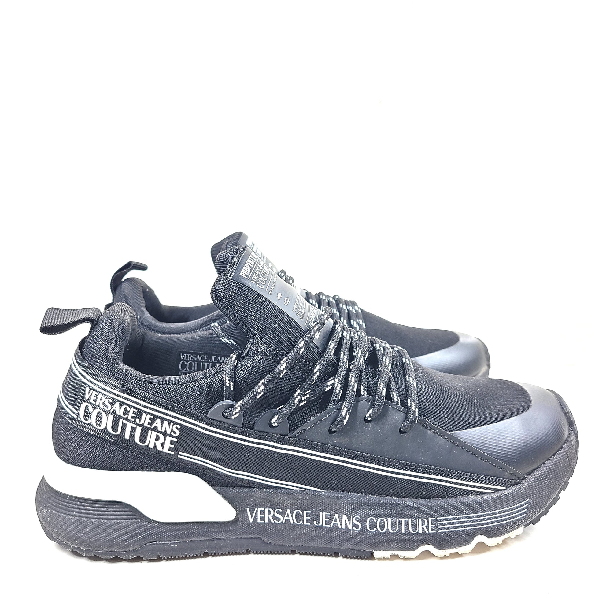 A pair of Versace Jeans Couture black sneakers with slight wear.