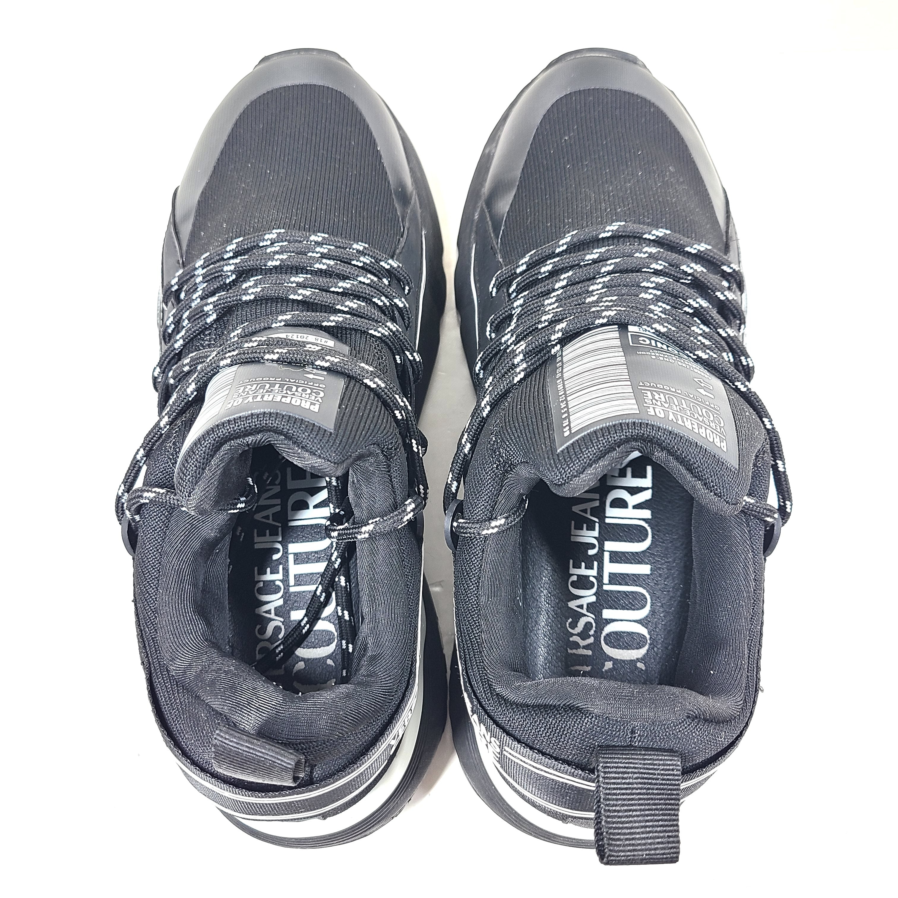 A pair of Versace Jeans Couture black sneakers with slight wear.