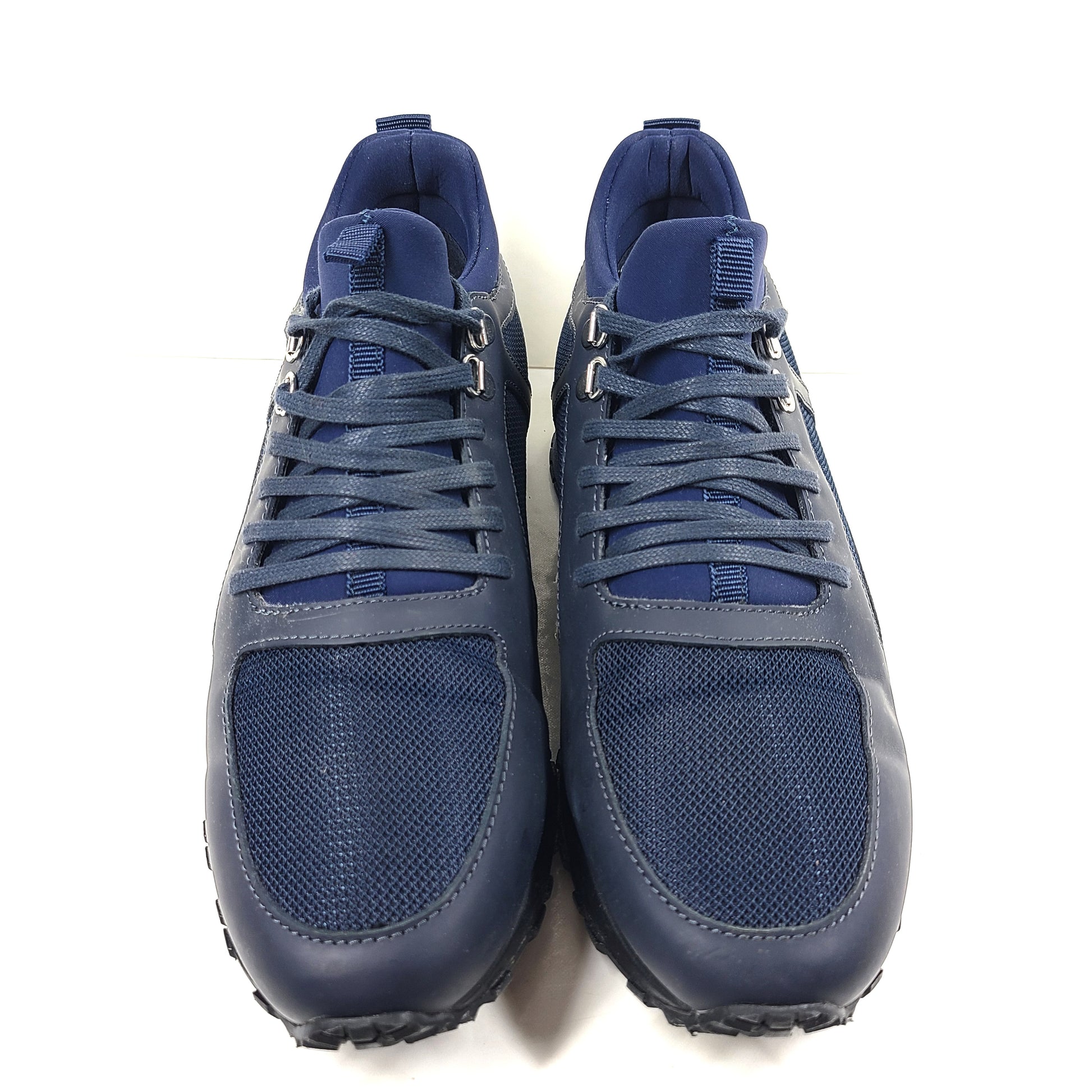 A pair of navy blue mesh and leather sneakers by Mallet.