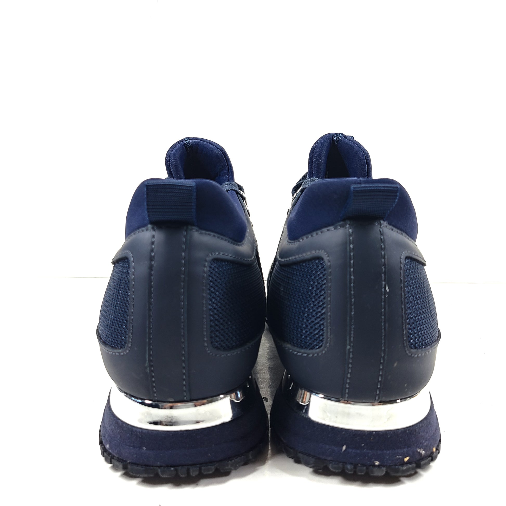 A pair of navy blue mesh and leather sneakers by Mallet.