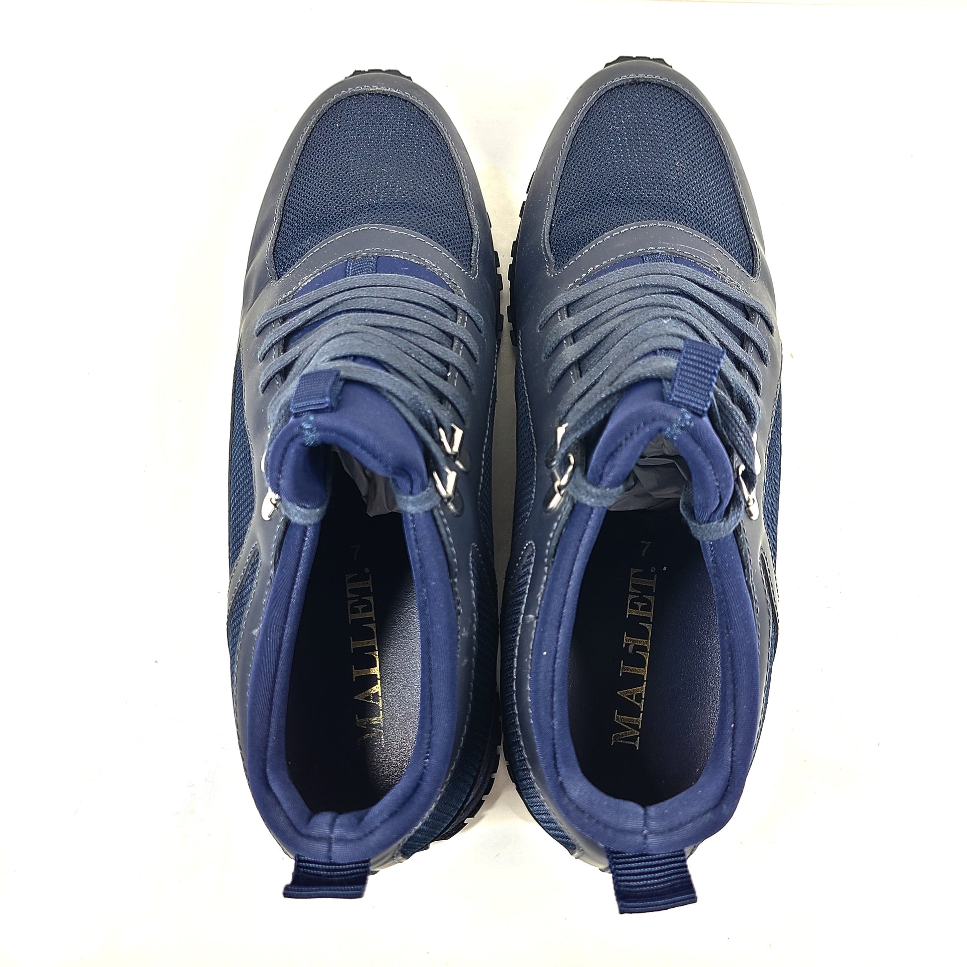 A pair of navy blue mesh and leather sneakers by Mallet.