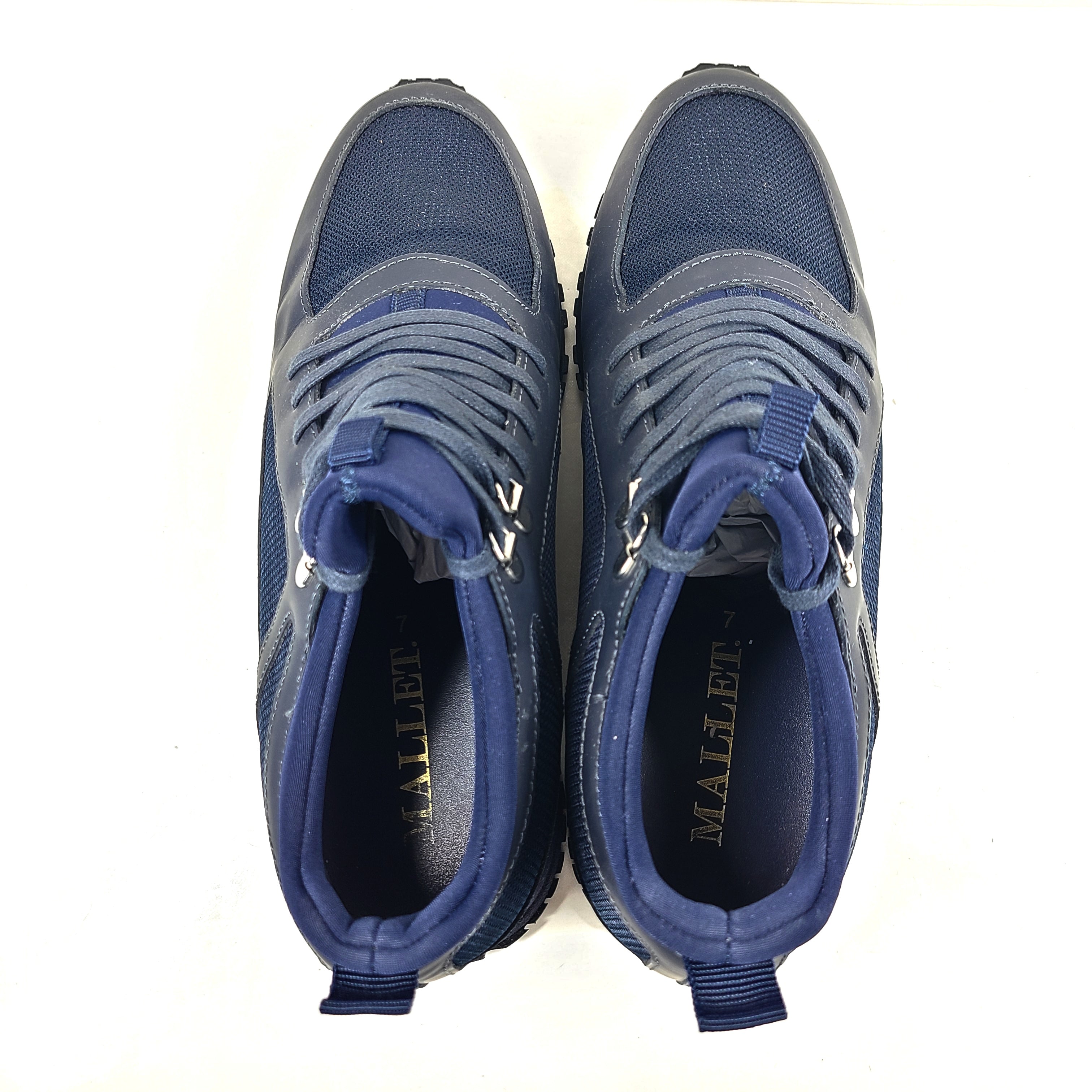A pair of navy blue mesh and leather sneakers by Mallet.