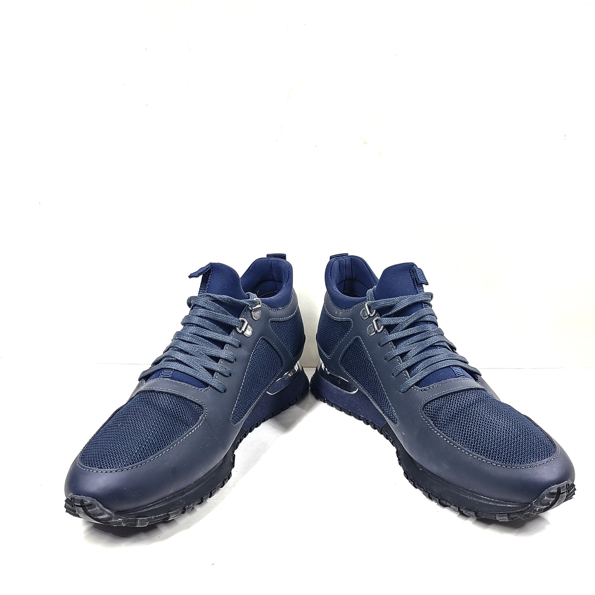 A pair of navy blue mesh and leather sneakers by Mallet.
