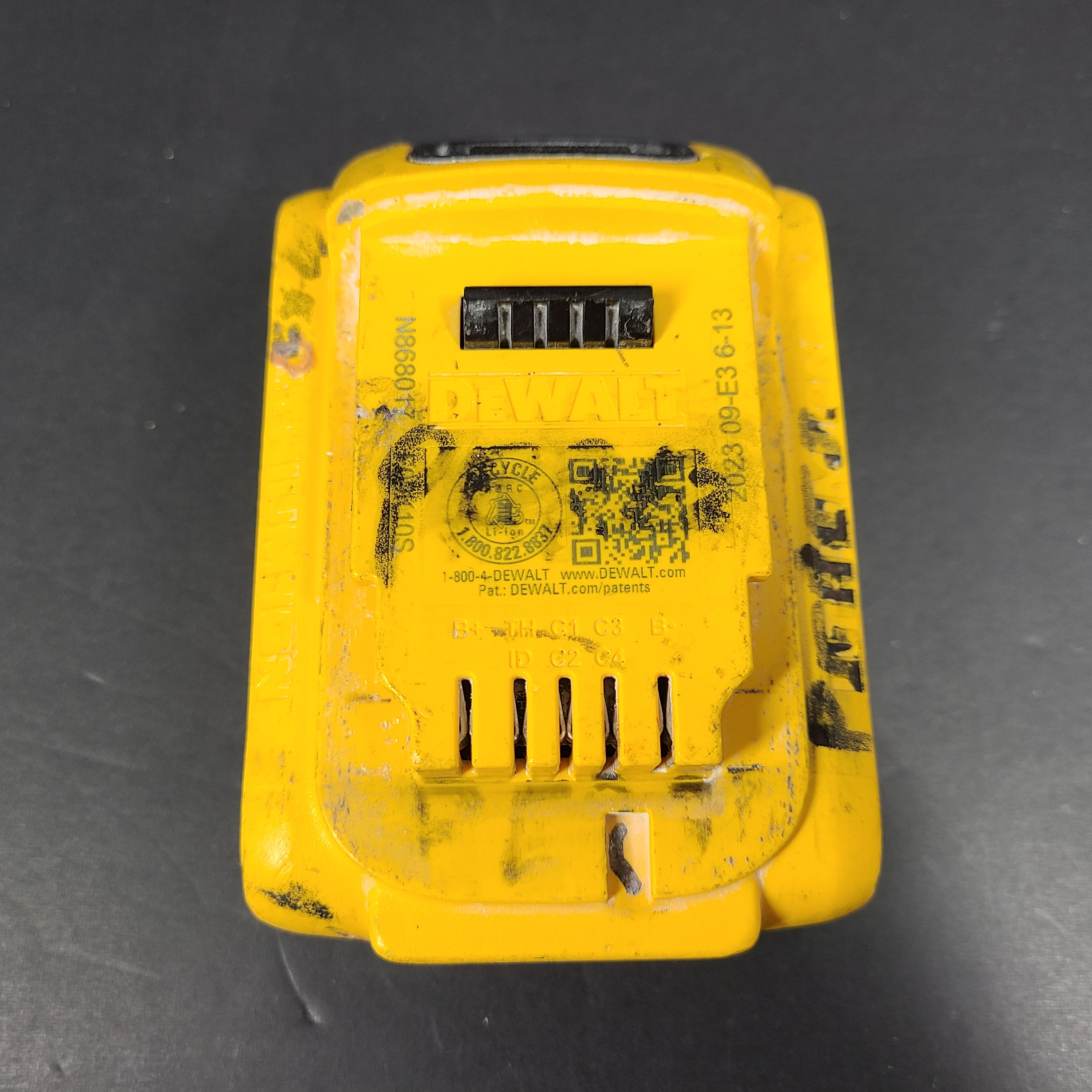 A pre-owned DeWalt XR Lithium-Ion Battery 20V Max 4Ah N089668 with noticeable wear.