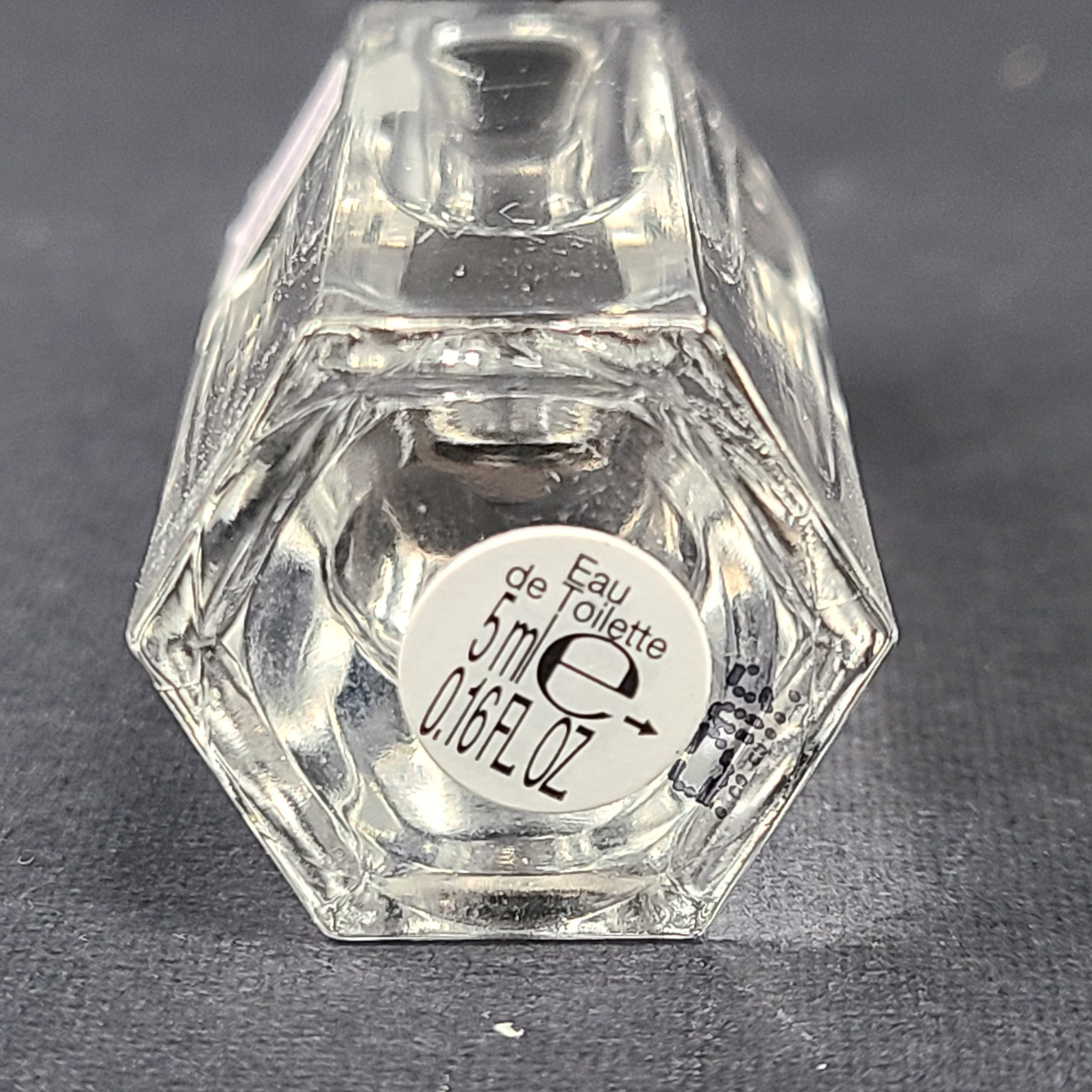 A small 5ml bottle of Gucci Flora Generous Violet Eau de Toilette perfume.