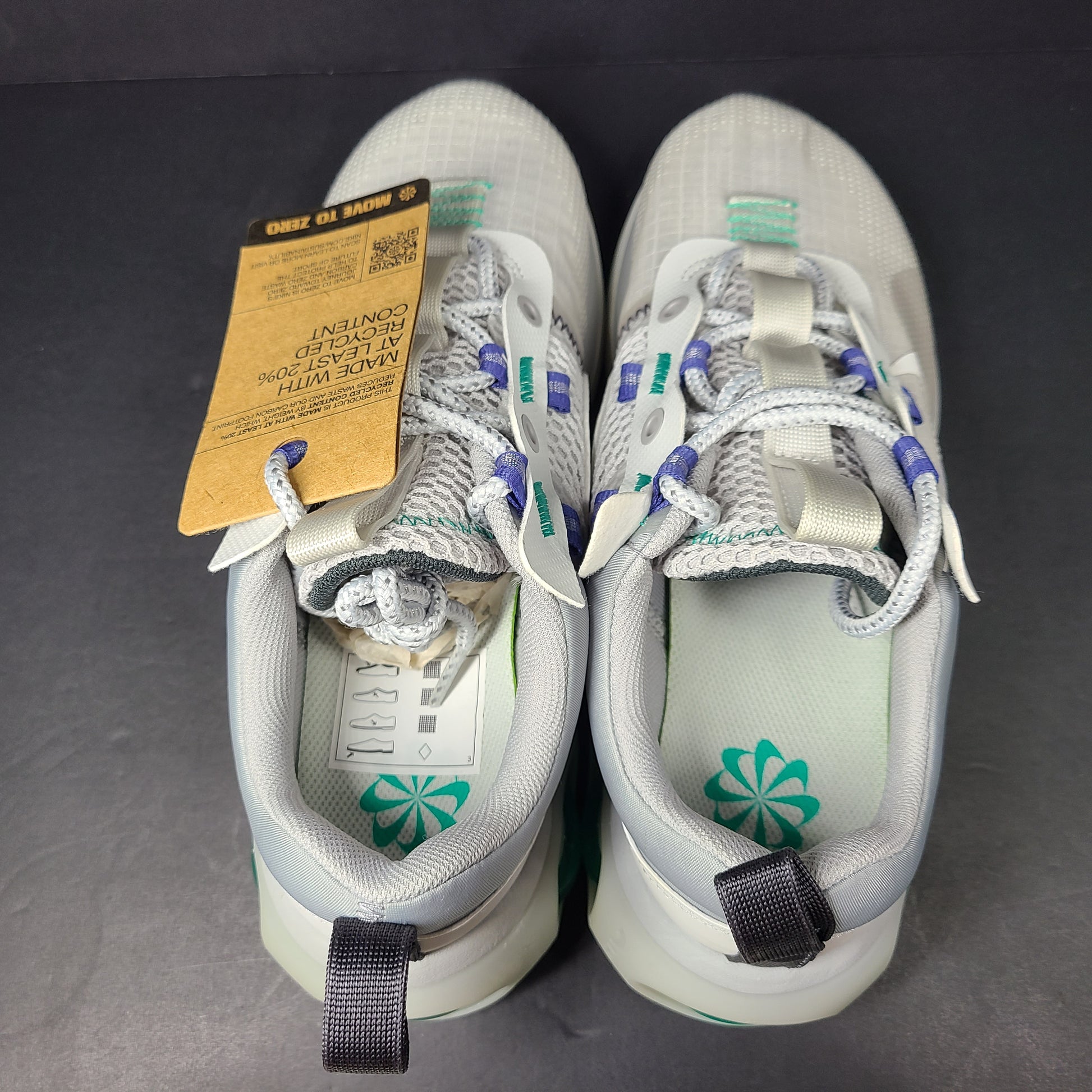 A stylish pair of men's Nike Air Max 2021 sneakers in white, green, and blue.