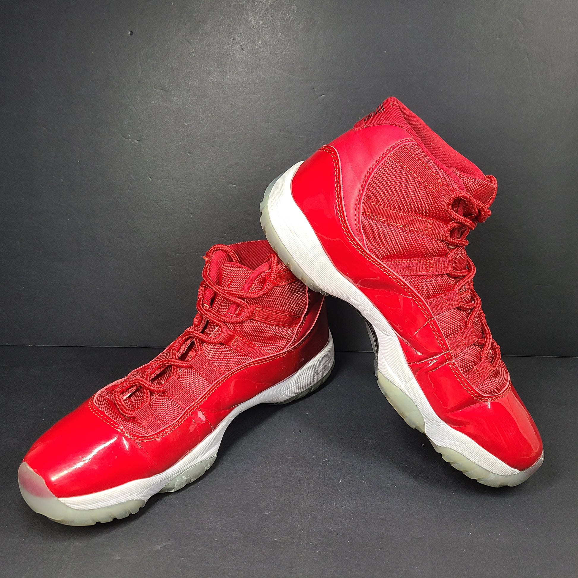 A pair of red Nike Air Jordan 11 Retro High men's sneakers.