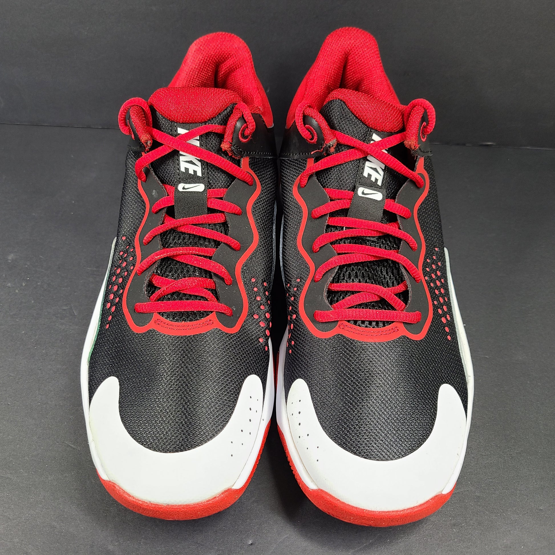 A pair of Nike men’s athletic shoes in black, red, and white.