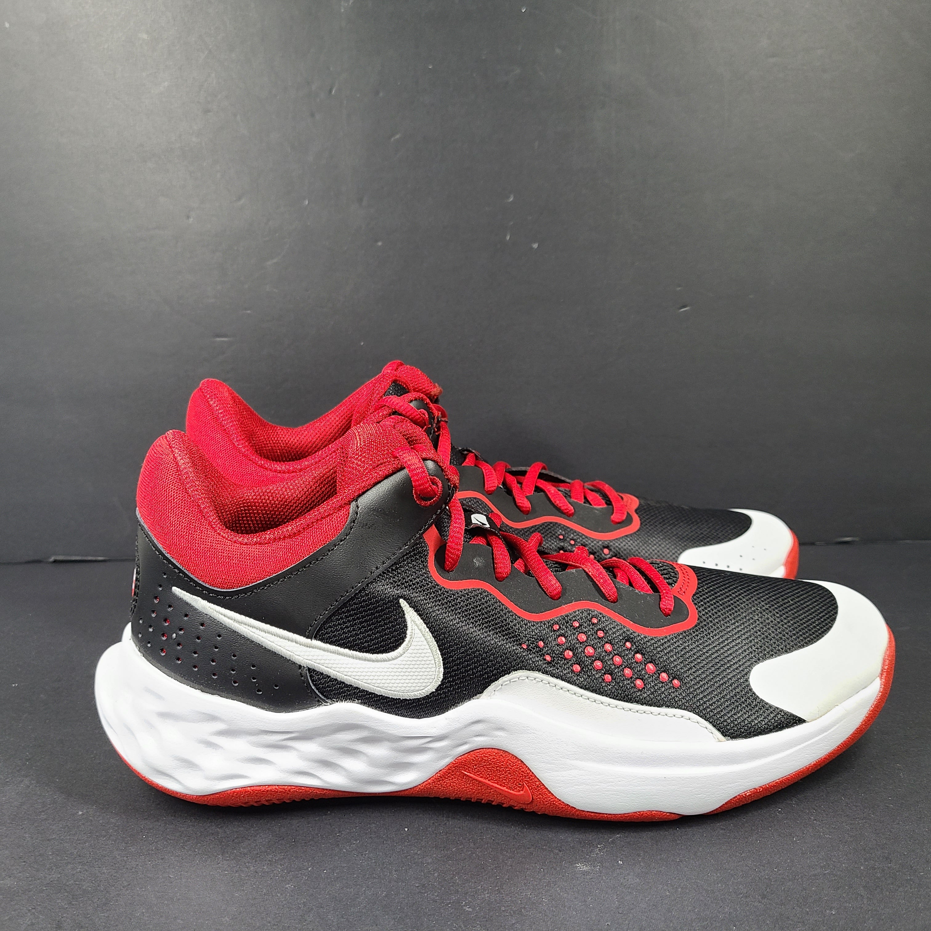 A pair of Nike men’s athletic shoes in black, red, and white.