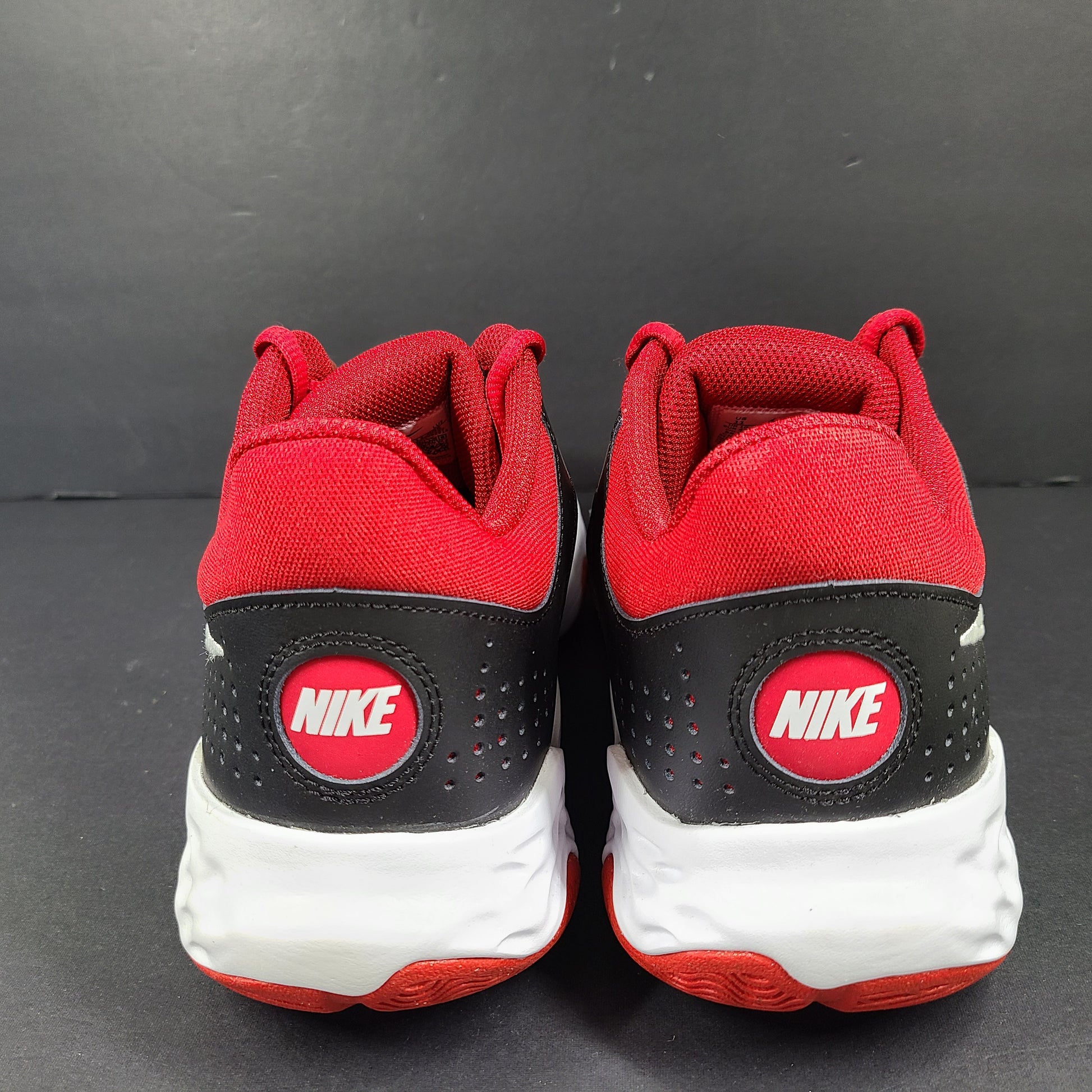 A pair of Nike men’s athletic shoes in black, red, and white.