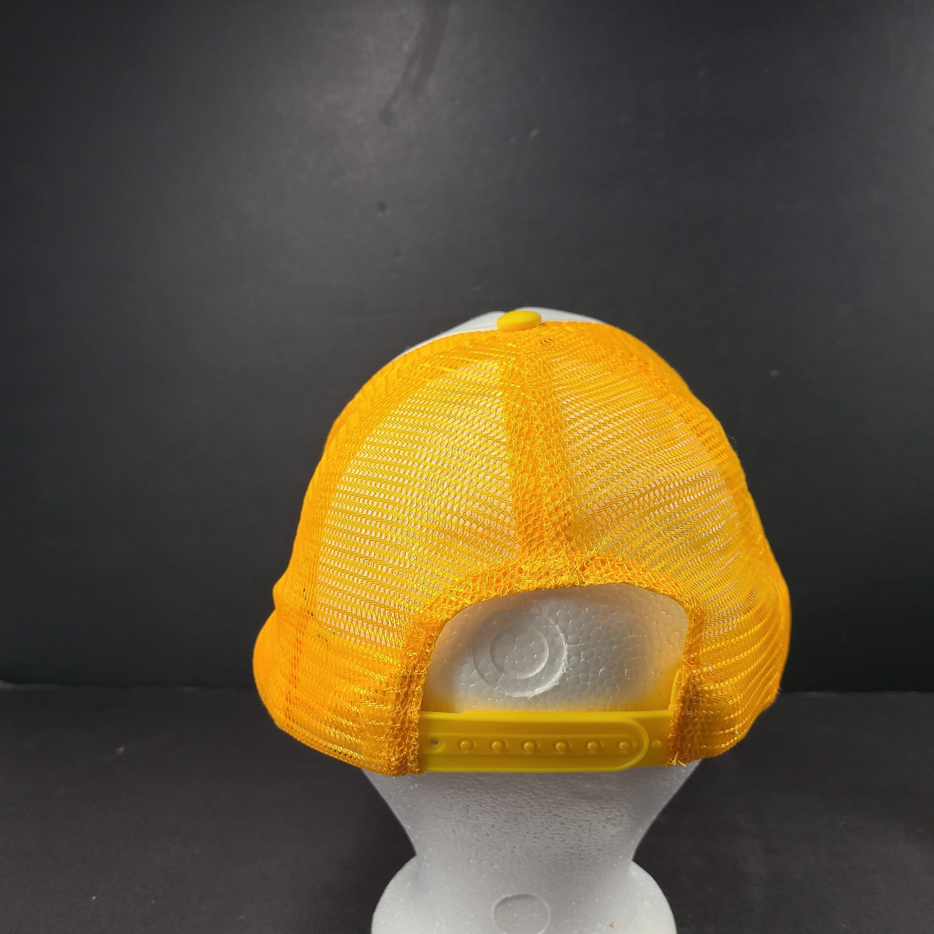 Comfortable Maison Article Trucker Cap in yellow and white mesh design.