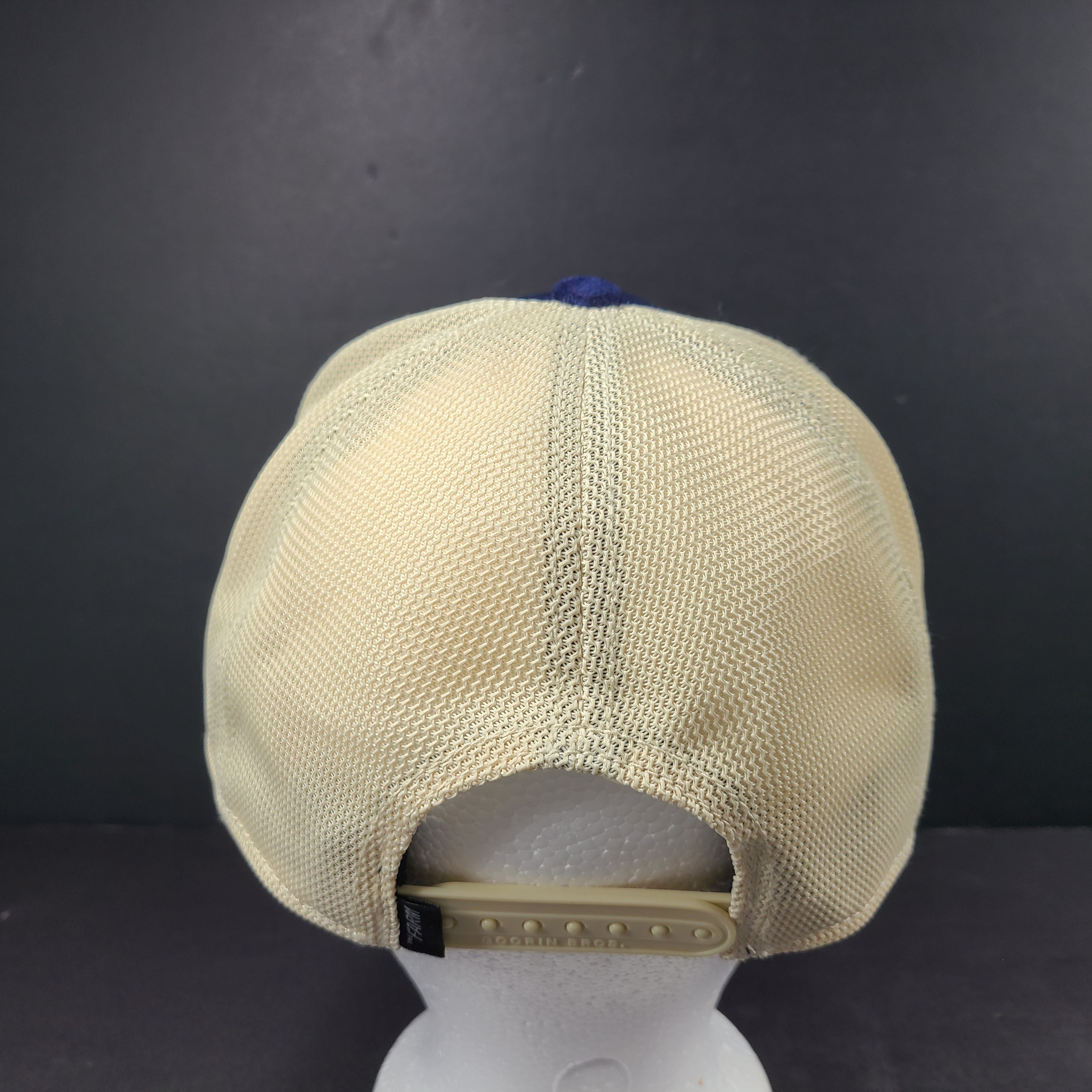 A stylish blue and beige trucker hat by Goorin Bros.