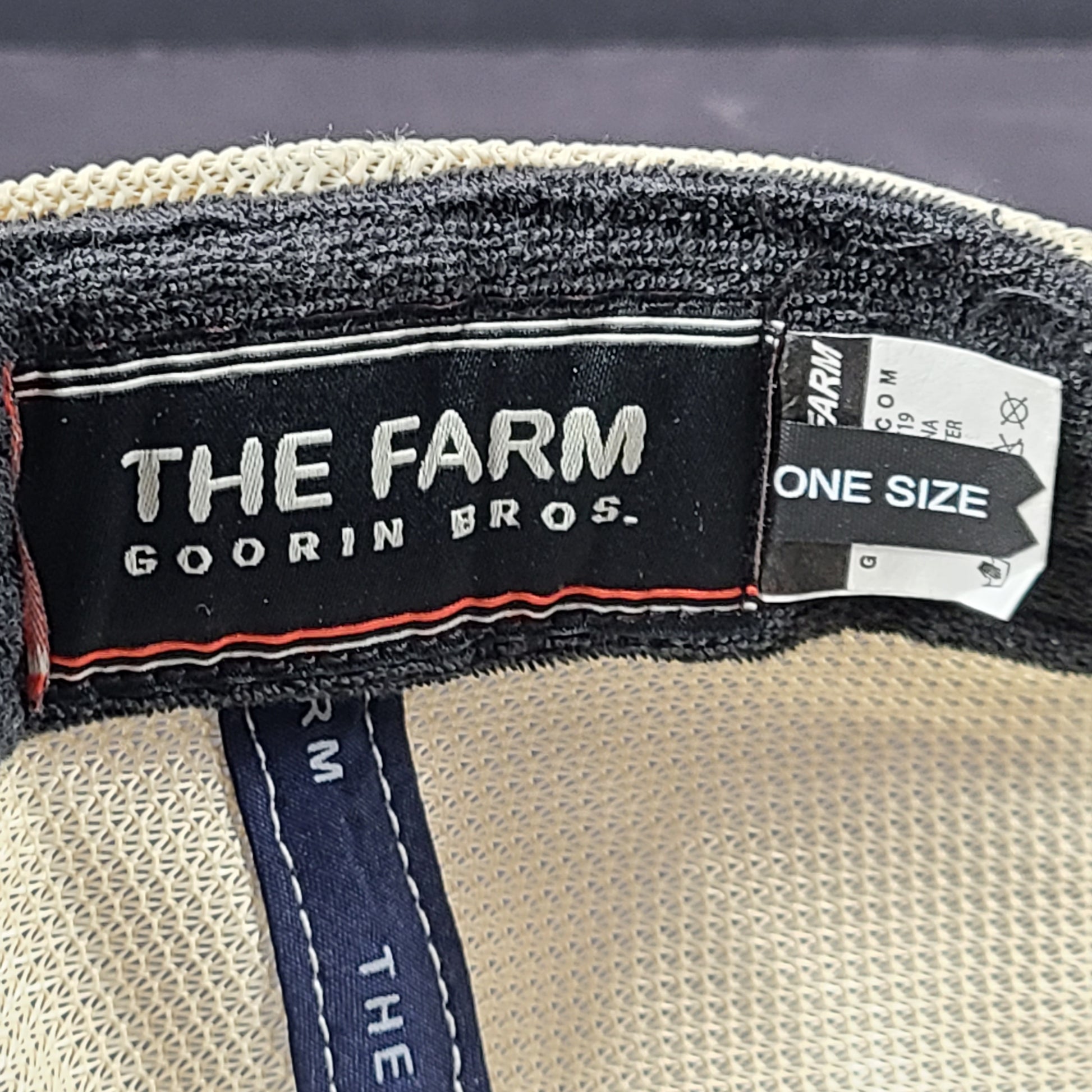 A stylish blue and beige trucker hat by Goorin Bros.