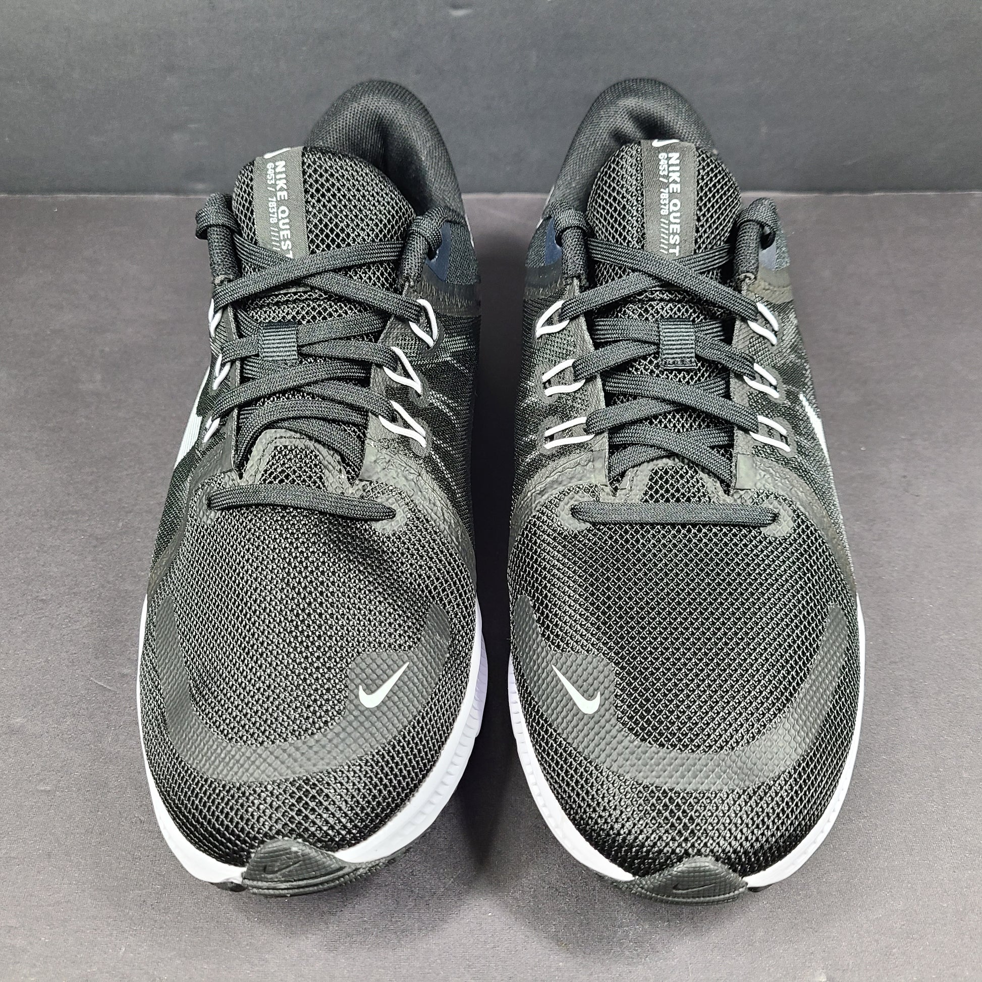 Sleek black Nike Quest 4 running shoes deliver lightweight cushioning and a streamlined fit for daily road runs.